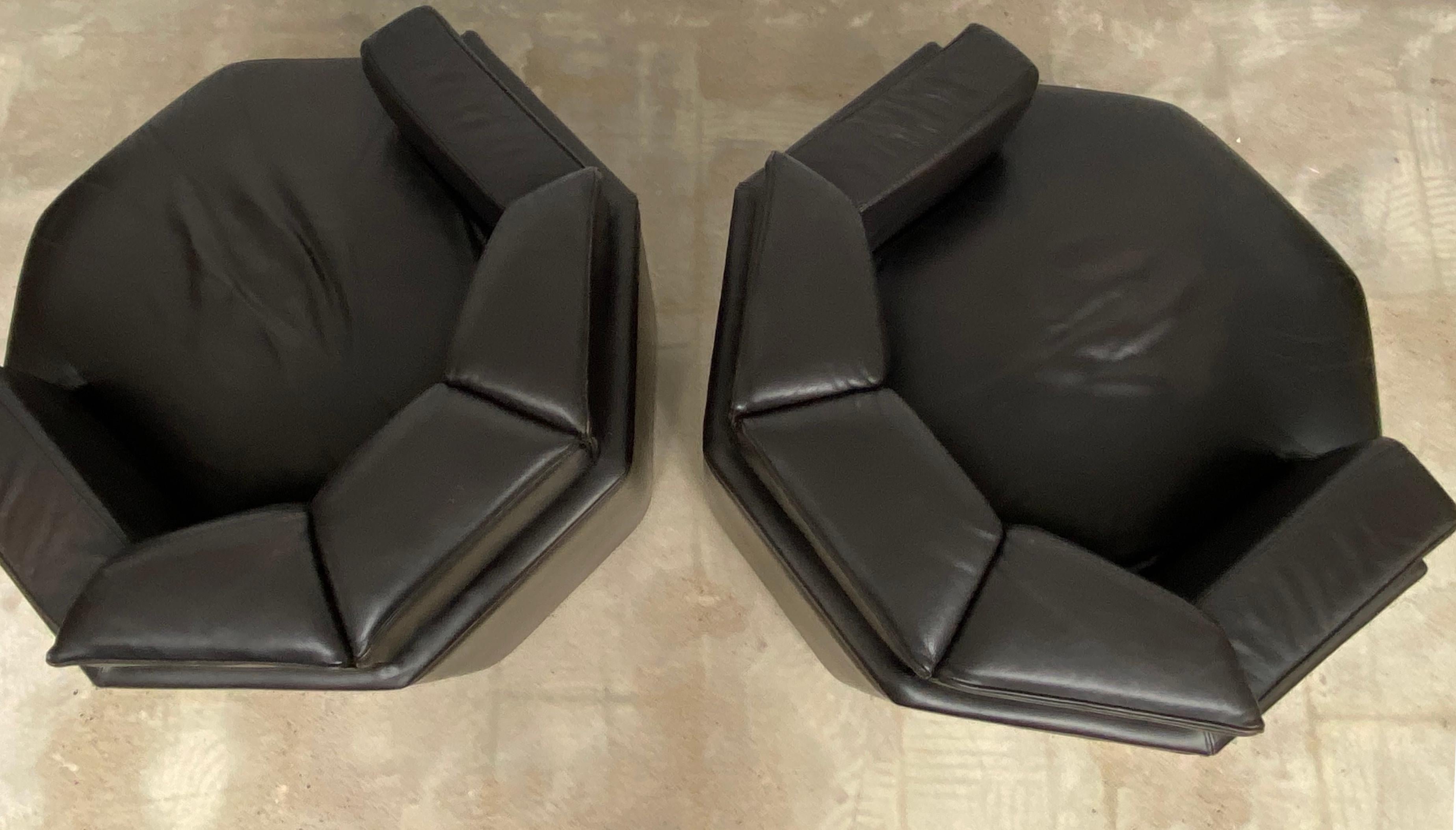Brown octagonal solid club chairs. The original segmented way of reupholstery makes these club chair both rare and unique in style and very comfortable in use. These uniquely shaped club chairs would very well suit an early 1970s James bond film