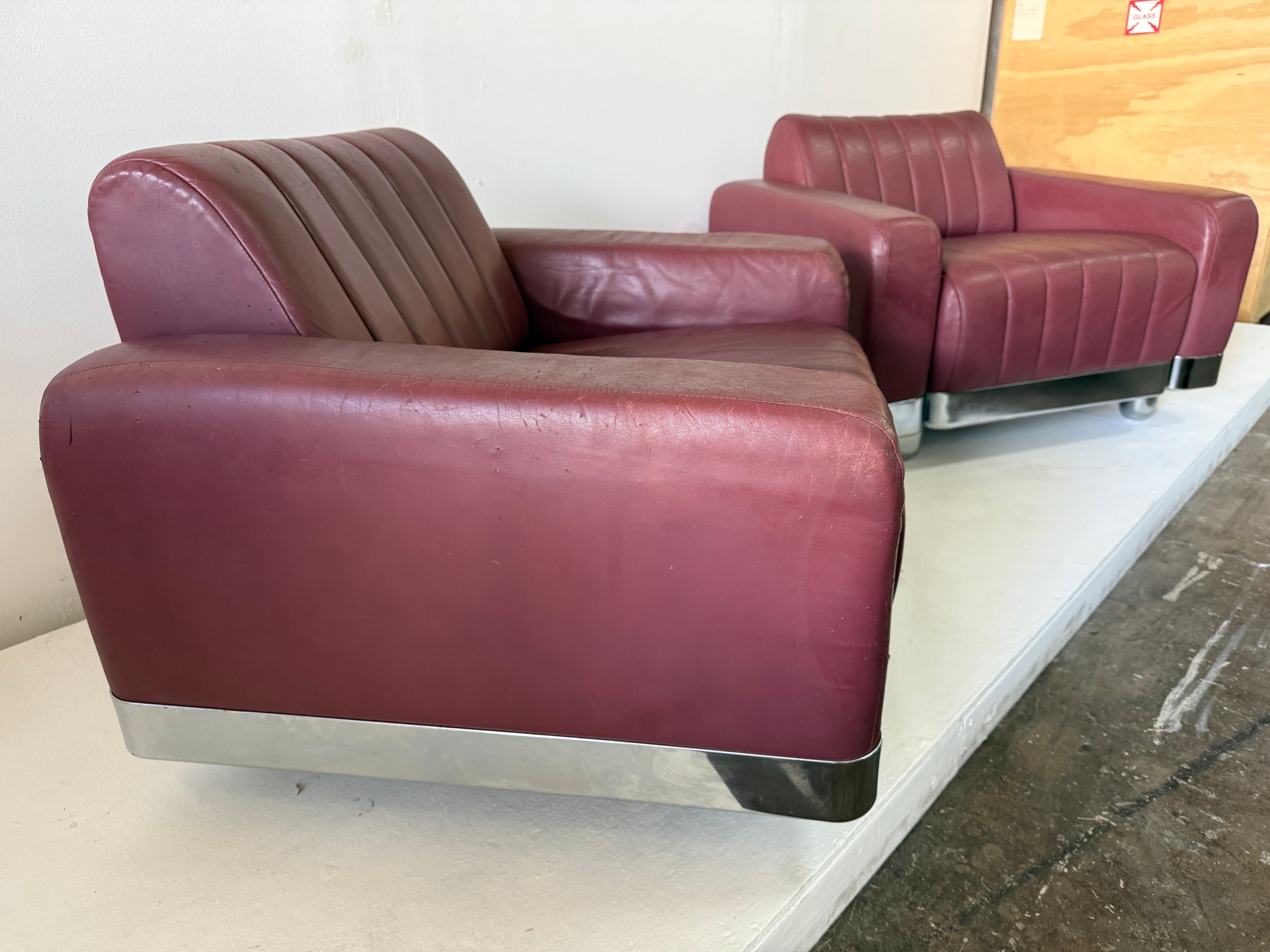 Chaises longues en chrome et cuir original d'inspiration Art déco des années 1970 et ottomans assortis par Brueton.  

NOTE :  dimensions des ottomans 24 pouces par 24 pouces, 15.5 pouces de hauteur