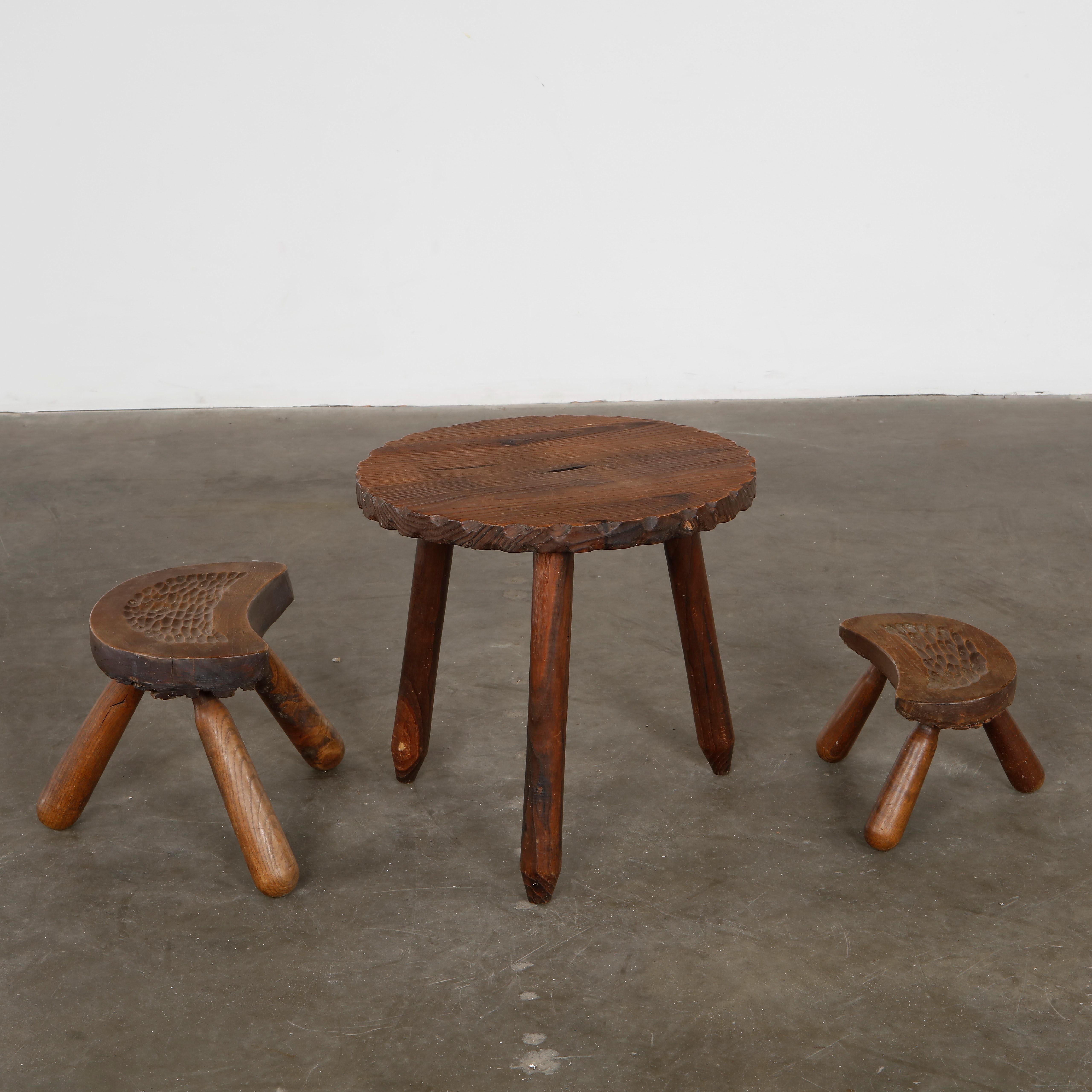 Primitive and sculptural set in solid wood. A striking trio with expressive grain and organic forms. Small Stool: Height: 7.9 in. Width: 12 in. Depth: 6 in. Taller Stool: Height: 11.5 in. Width: 14.5 in. Depth: 7.5 in. Coffee Table: Height: 18.1 in.