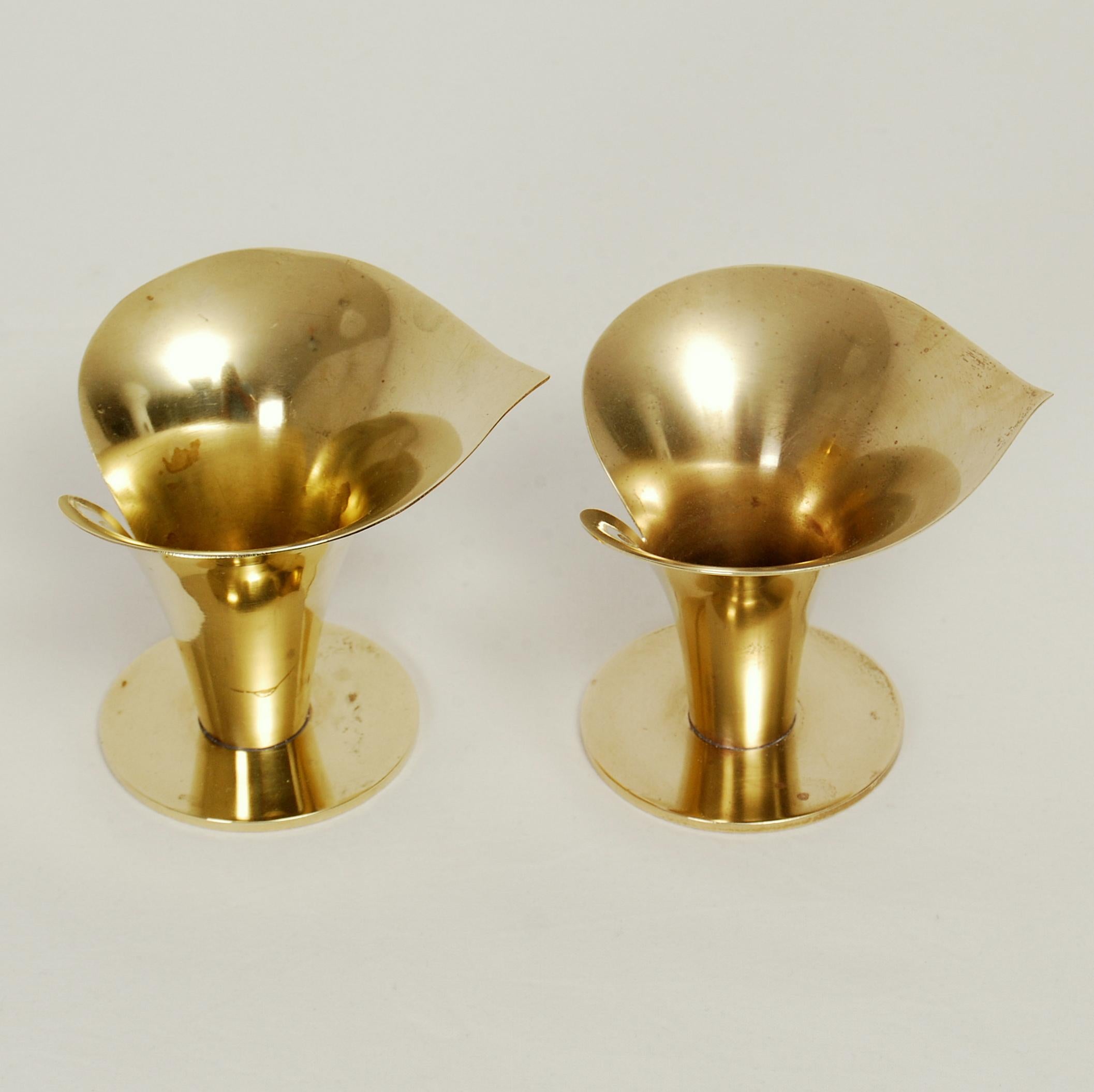 A set of two Carl Einar Borgström flower-shaped candle holders in brass. Manufactured by Ystad Metall. Stamped and signed.
 