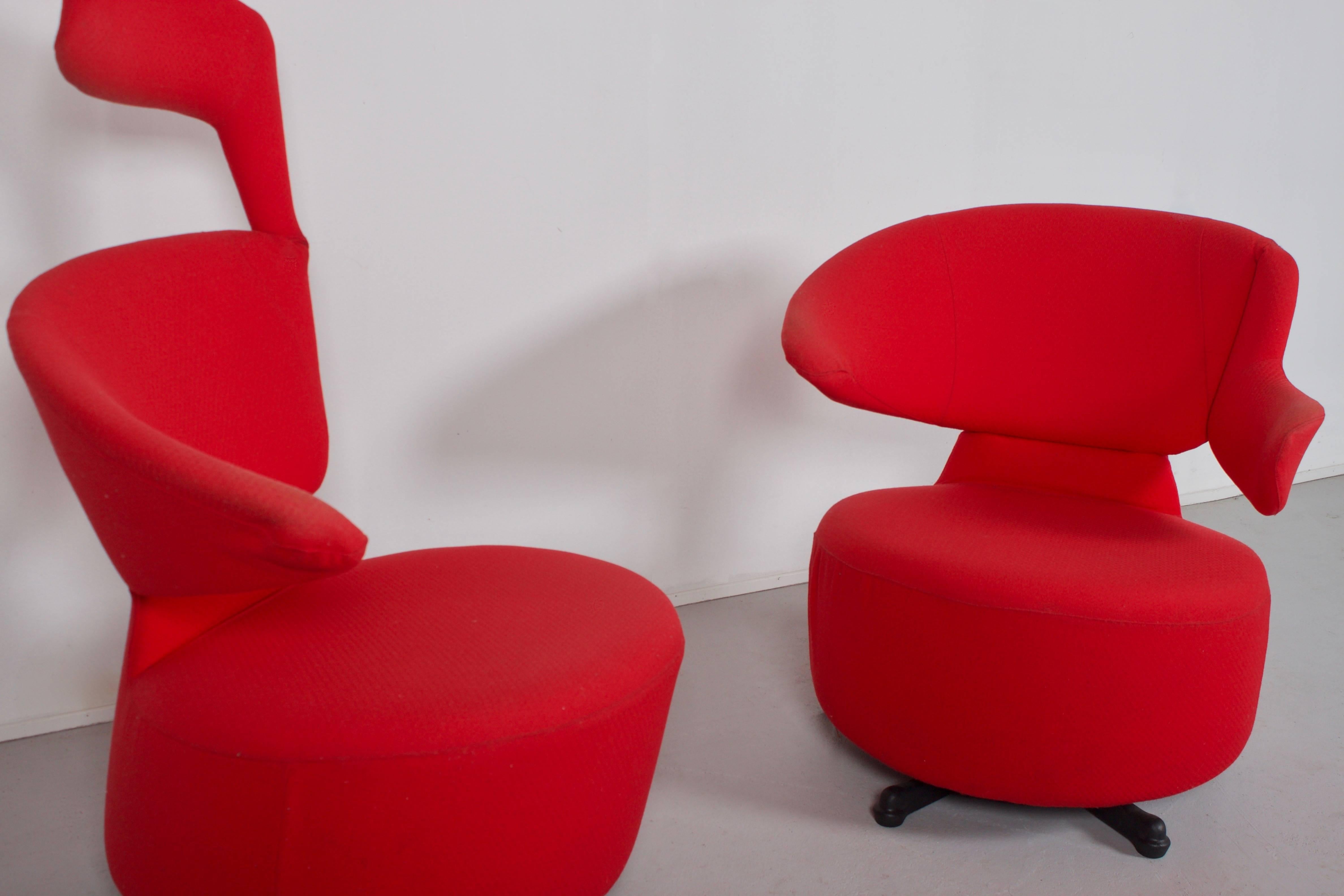 Swivel armchairs by Toshiyuki Kita by Cassina in good condition.

Red removable fabric cover.

Steel base with moulded black polyurethane casting.

The right arm can move upwards and can be used as a headrest.

Also, see our set of 'Biki' chairs in