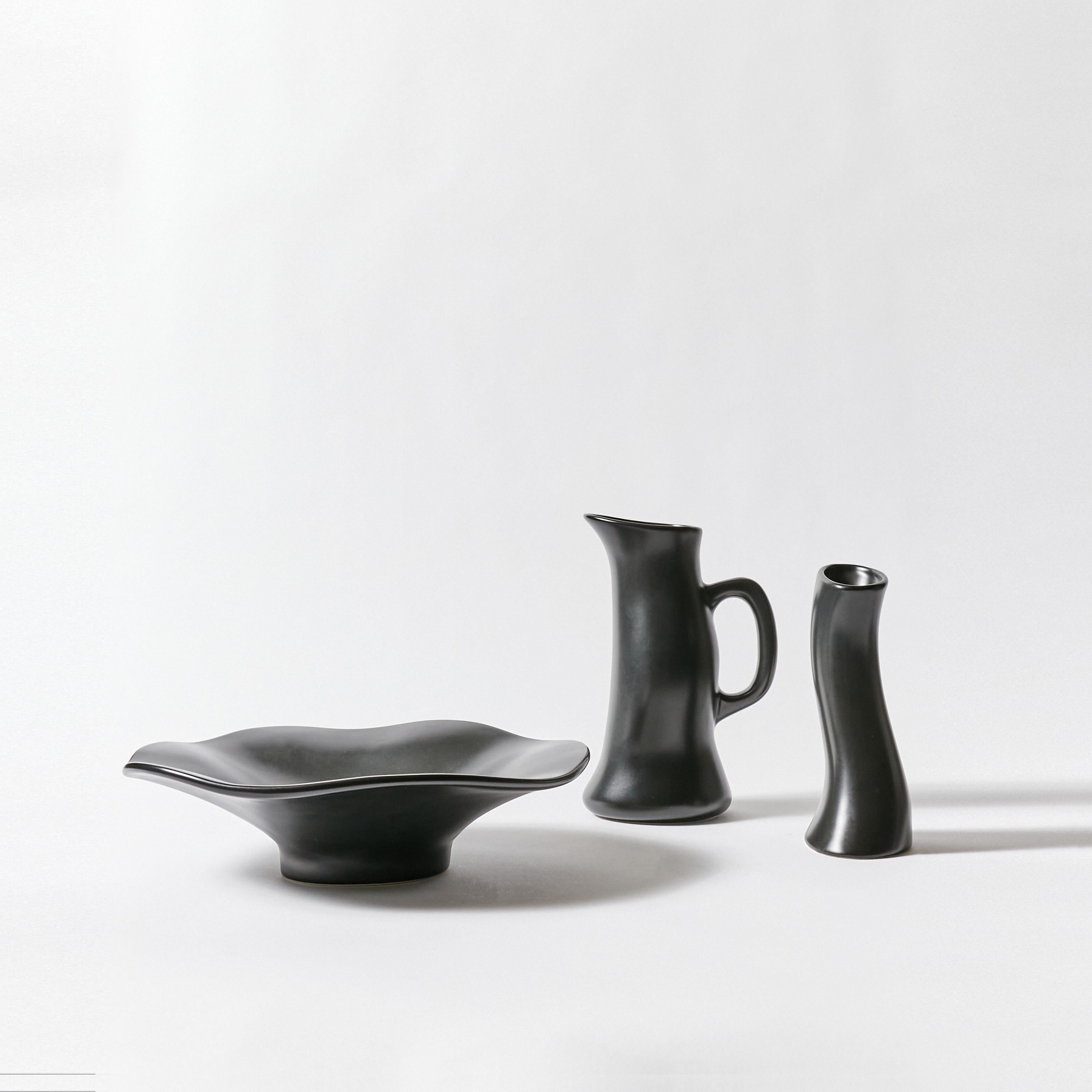 Set of ceramic fruit bowl, pitcher and tall vase designed by Robert Welch. All three pieces show a free form/organic shape and they are finished in black satin glaze. Signature stamp on bottom.

Pitcher
Height 9 in/ 22.86 cm
Width 4.5 In / 11.43