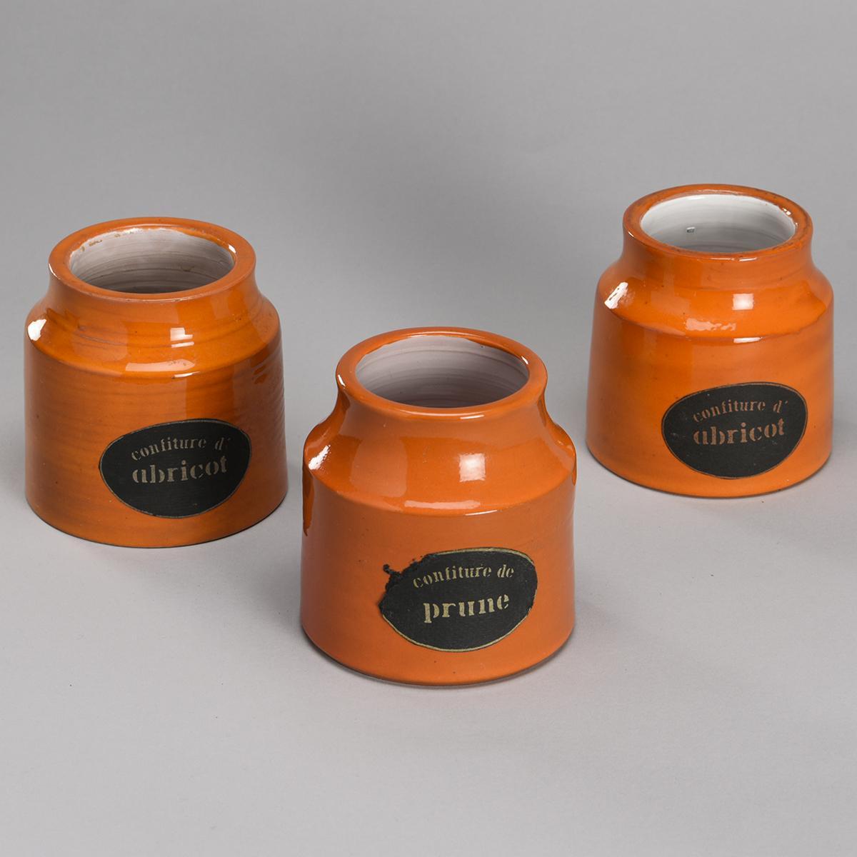 Set of 3 glazed ceramic cylindrical jars with tightened necks with a beautiful orange enamel with their original label 