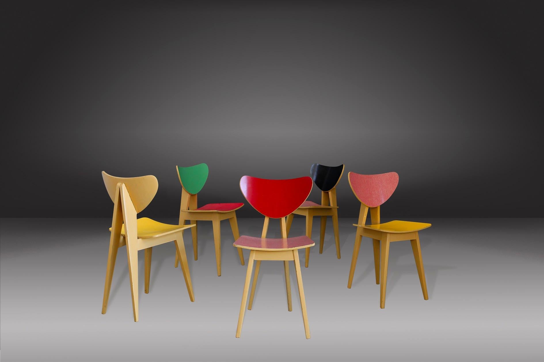 Eccentric coloured ant set from the 1950s. The structure of the set of chairs is made of cream-colored lacquered wood. Their peculiarity, as you can see in the photos, each chair is of a different color covered in ant. The condition of the chairs