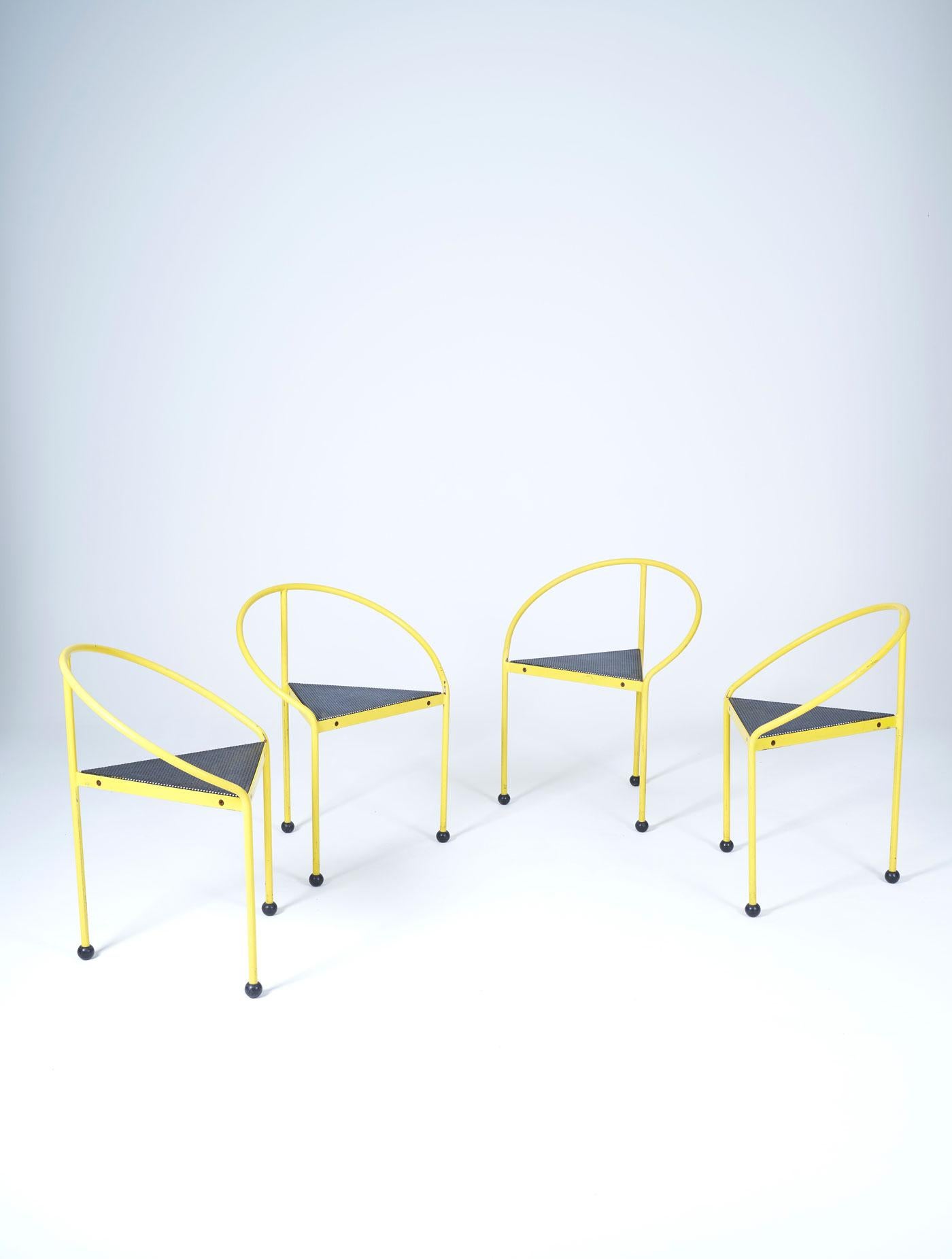 Set of 4 chairs model 'Bermuda' by designer Carlos Miret for Amat in the 1980s (1986). Yellow lacquered iron frame and perforated metal seat. This Memphis-style tripod chair will complement furniture by designers Ettore Sottsass, Andrea Branzi,