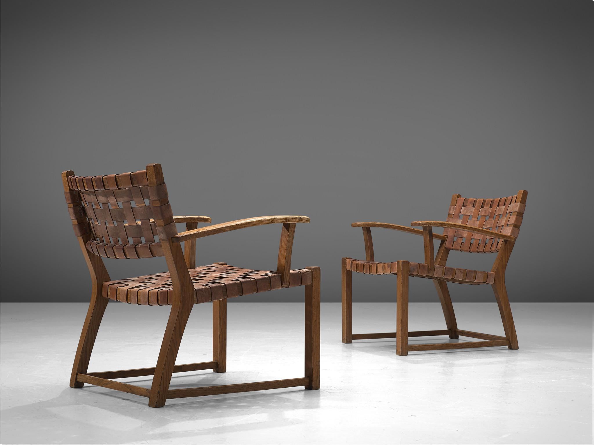 Set of chairs, leather and oak, Scandinavia, 1950s.

These robust chairs feature wonderful patinated leather on both seat and back. The patina creates a vibrant look and the straps in the seat form a thick, well-constructed yet aesthetically