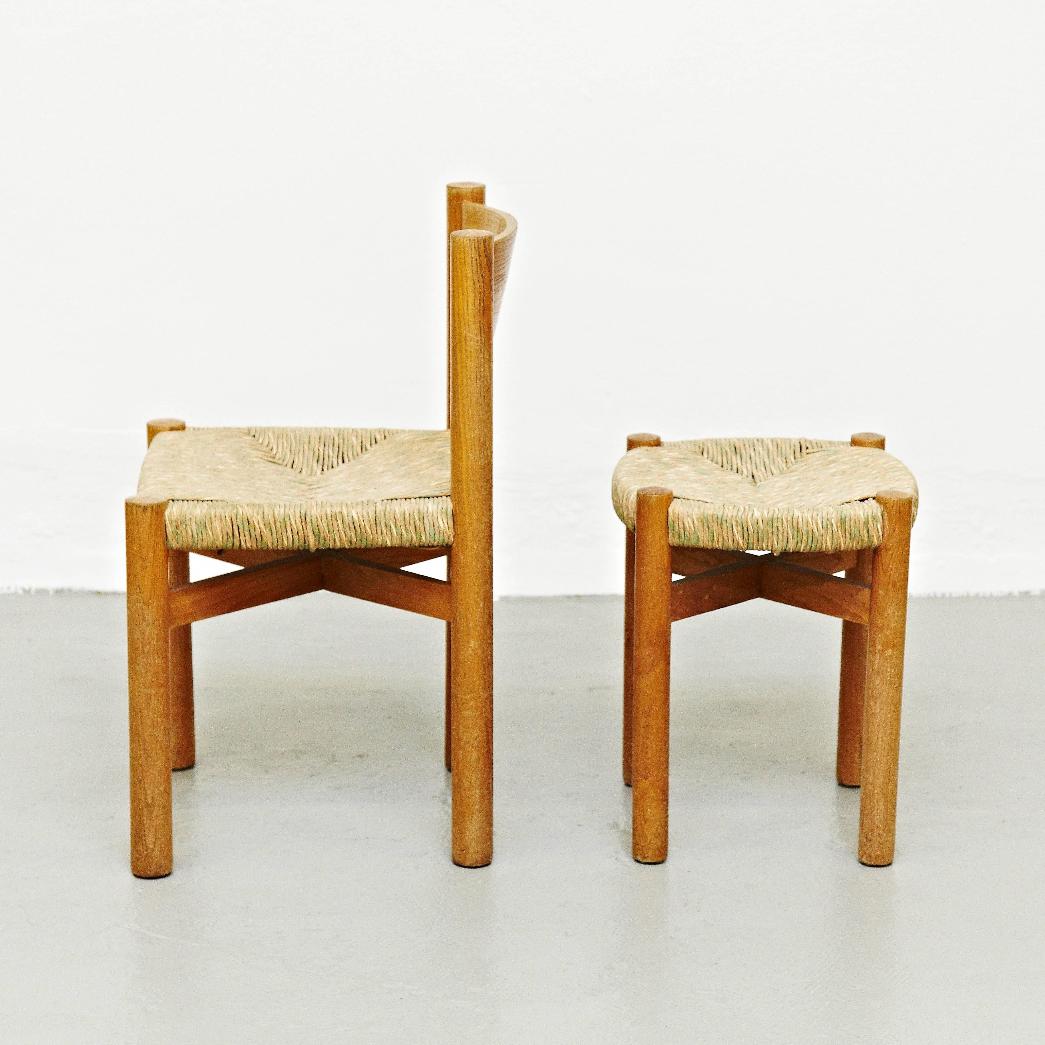 Chair and stool, model meribel, designed by Charlotte Perriand, circa 1950, manufactured in France.

Wood and rattan.

In good original condition, with minor wear consistent with age and use, preserving a beautiful patina.

Charlotte Perriand