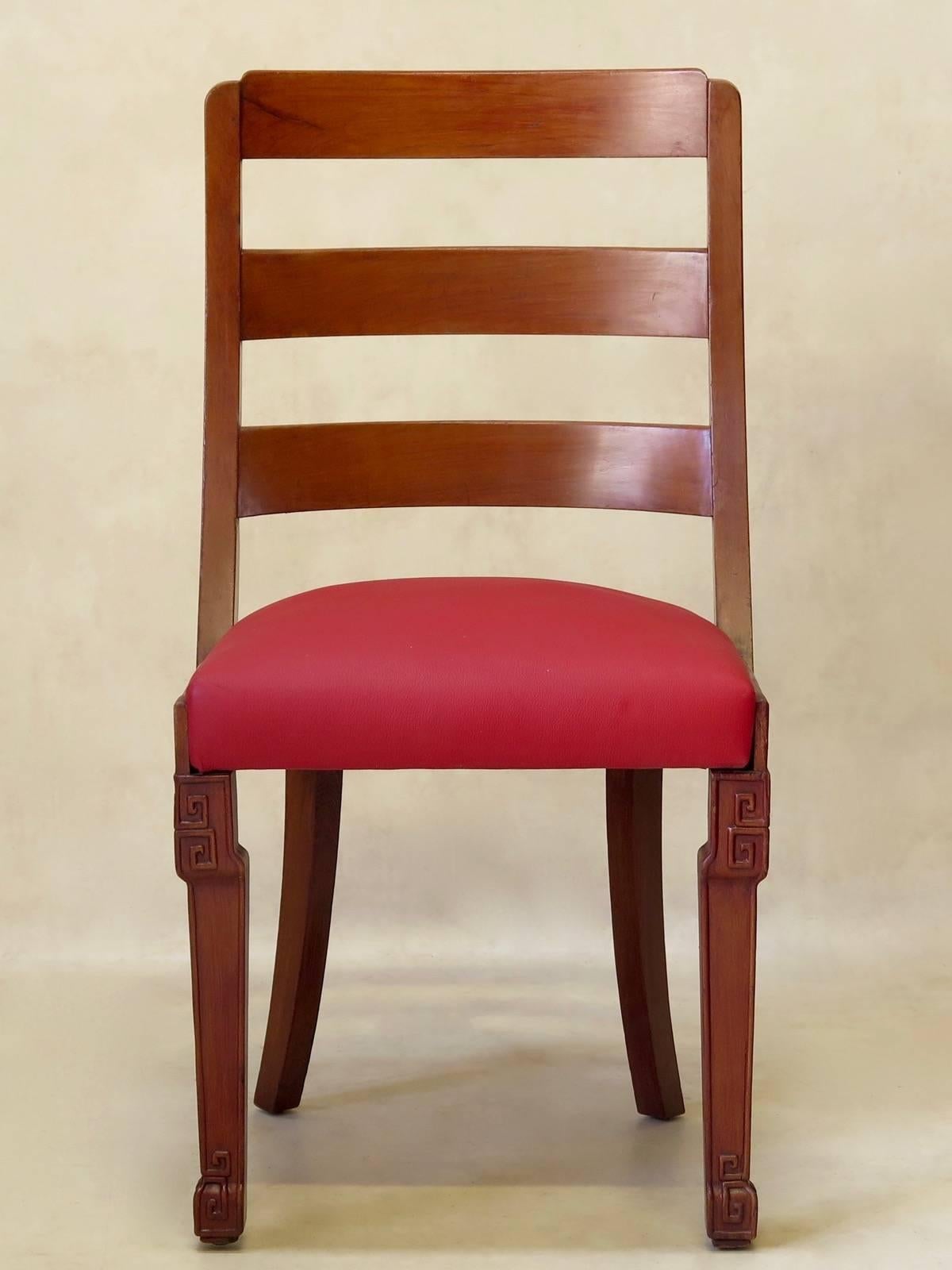 Attractive set of six Chinese Art Deco dining chairs with agreeable, rounded backs, saber back legs, and minimally engraved front legs. The seats are upholstered in cerise red leather.