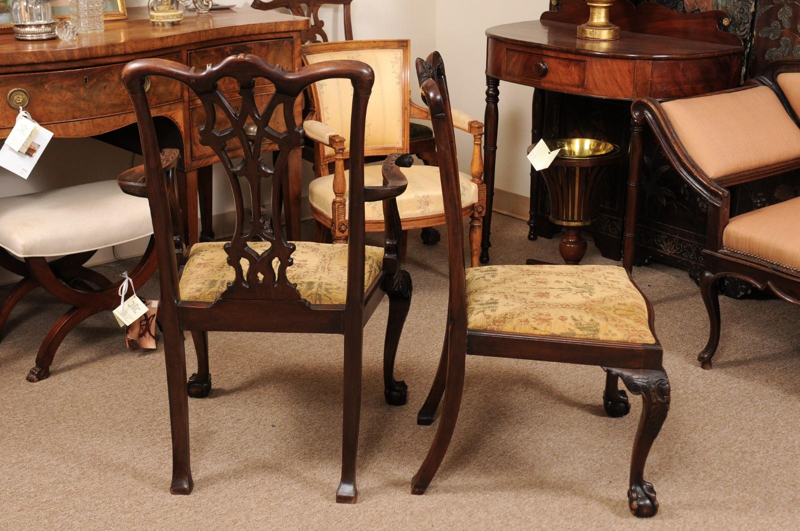 Set of 19th century English Chippendale style dining chairs in mahogany with pierced backsplats, ball & claw feet, and upholstered slip seats. Set includes 2 armchairs and 6 side chairs.
Arm chair dimensions: 26