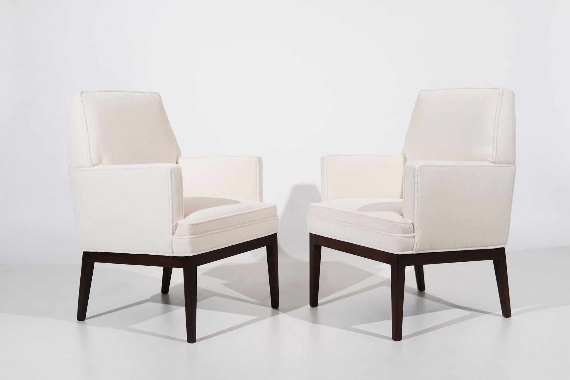 Discover the timeless allure of a rare set of club chairs designed by Jens Risom in the late 1960s, now meticulously restored for a contemporary touch. The walnut legs have undergone a complete restoration, ensuring their original beauty shines