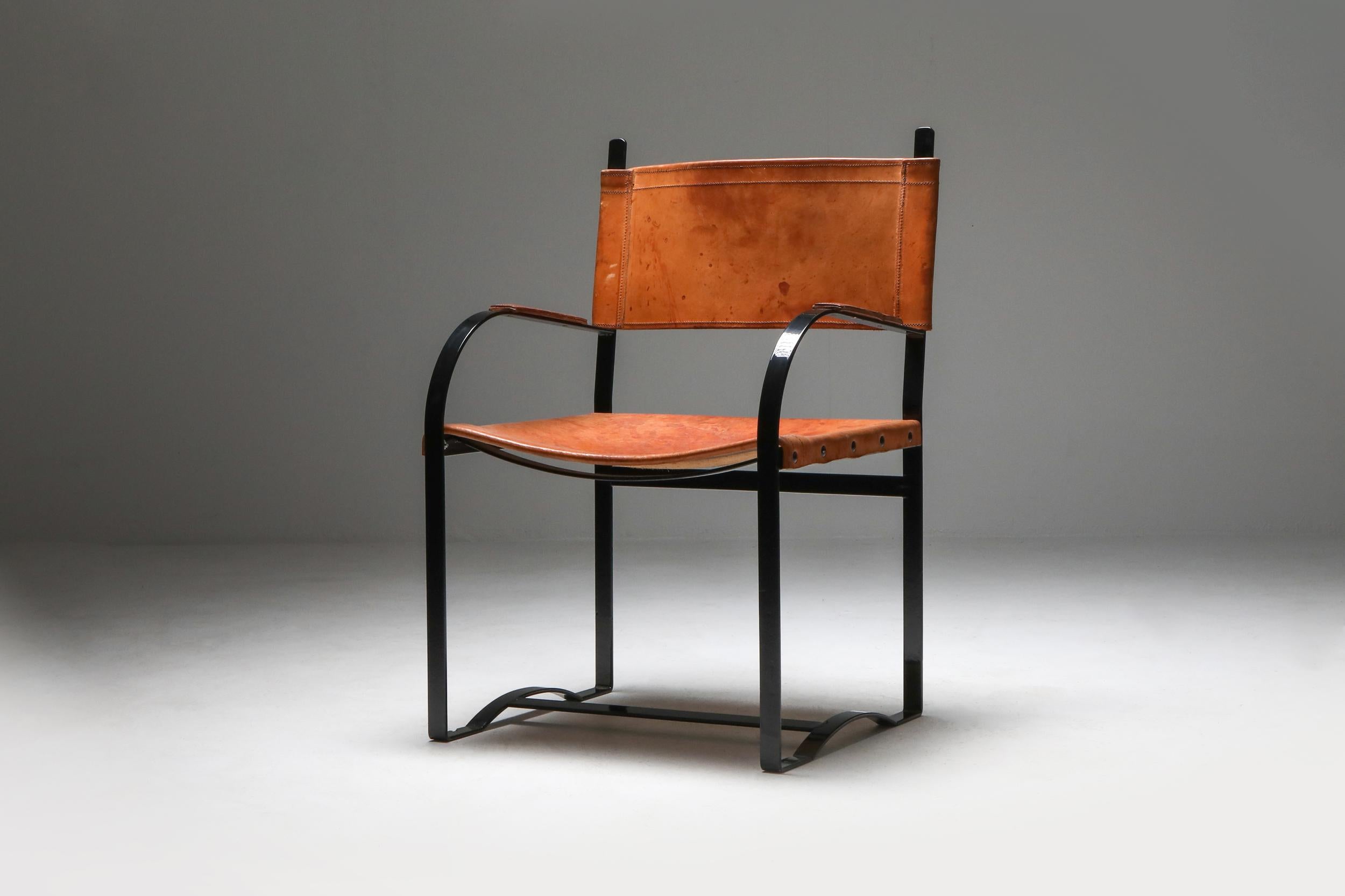 Black lacquer steel and patinated cognac leather chairs, Belgium, the 1960s
Unusual and wide armchairs, thick leather seating, solid steel frame
They would fit well in a rustic modern, chalet-style interior.
 
 