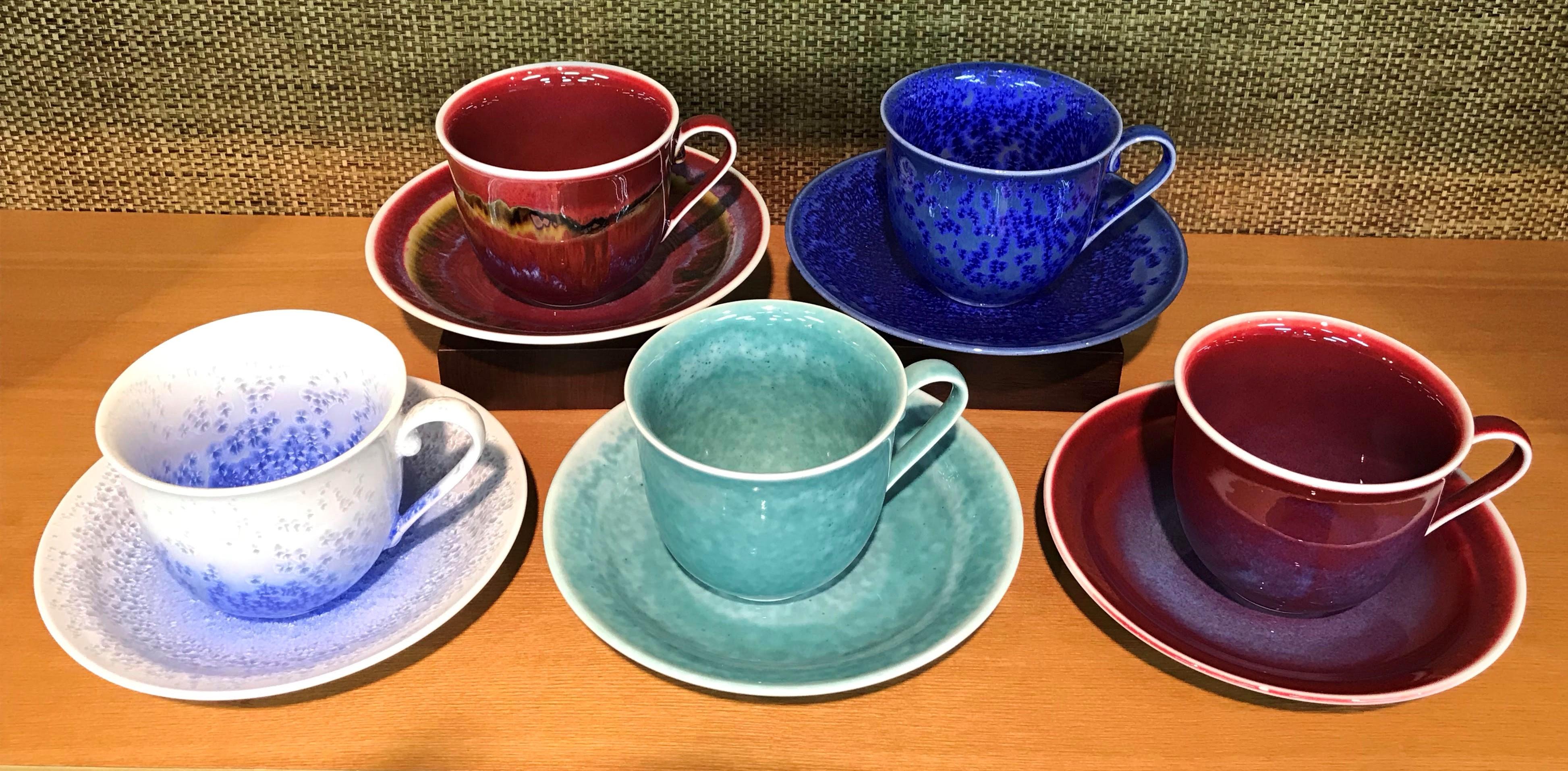 Stunning set of five contemporary Japanese hand-glazed porcelain cups and saucers in a beautiful shape masterfully glazed to showcase the artist's signature glazing techniques, signed works by widely respected award-winning master porcelain artist
