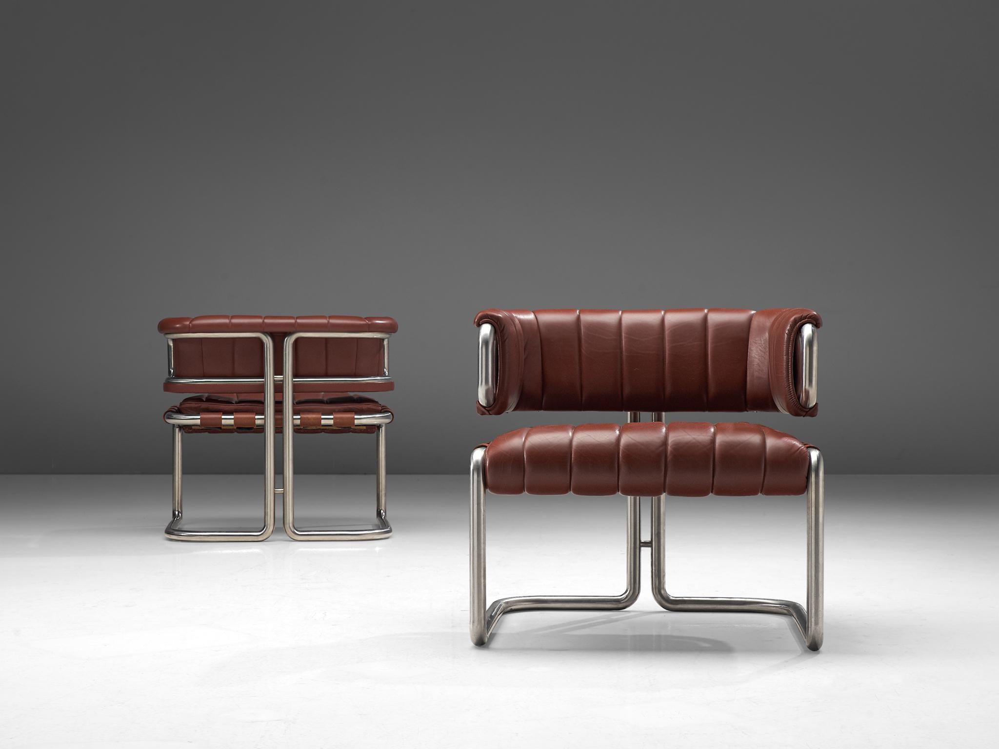 Set of three lounge chairs, leather and metal, Germany, 1960s

Set of three dark red leather chairs with metal tubular steel. This set is characterized by clear, straight lines that are noticeable in the leather as well. The frame of these chairs is