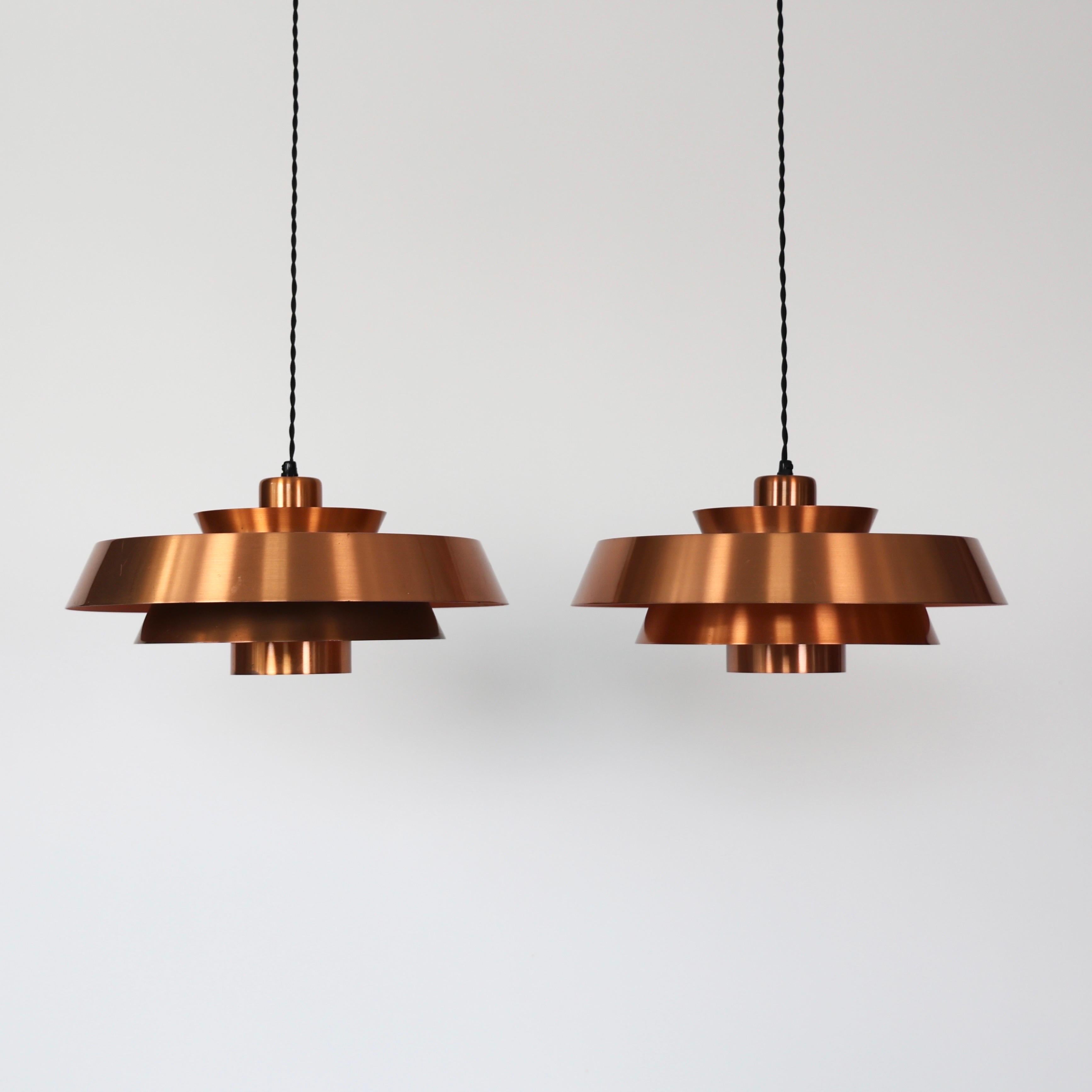 Set of Modern Copper Pendant lights designed by Jo Hammerborg for Fog & Mørup in the 1960s. 

* Set (2) of copper lacqured pendant lights. Orange / white on the inside.
* Designer: Jo Hammerborg
* Model: Nova
* Producer: Fog & Mørup, Denmark
* Year: