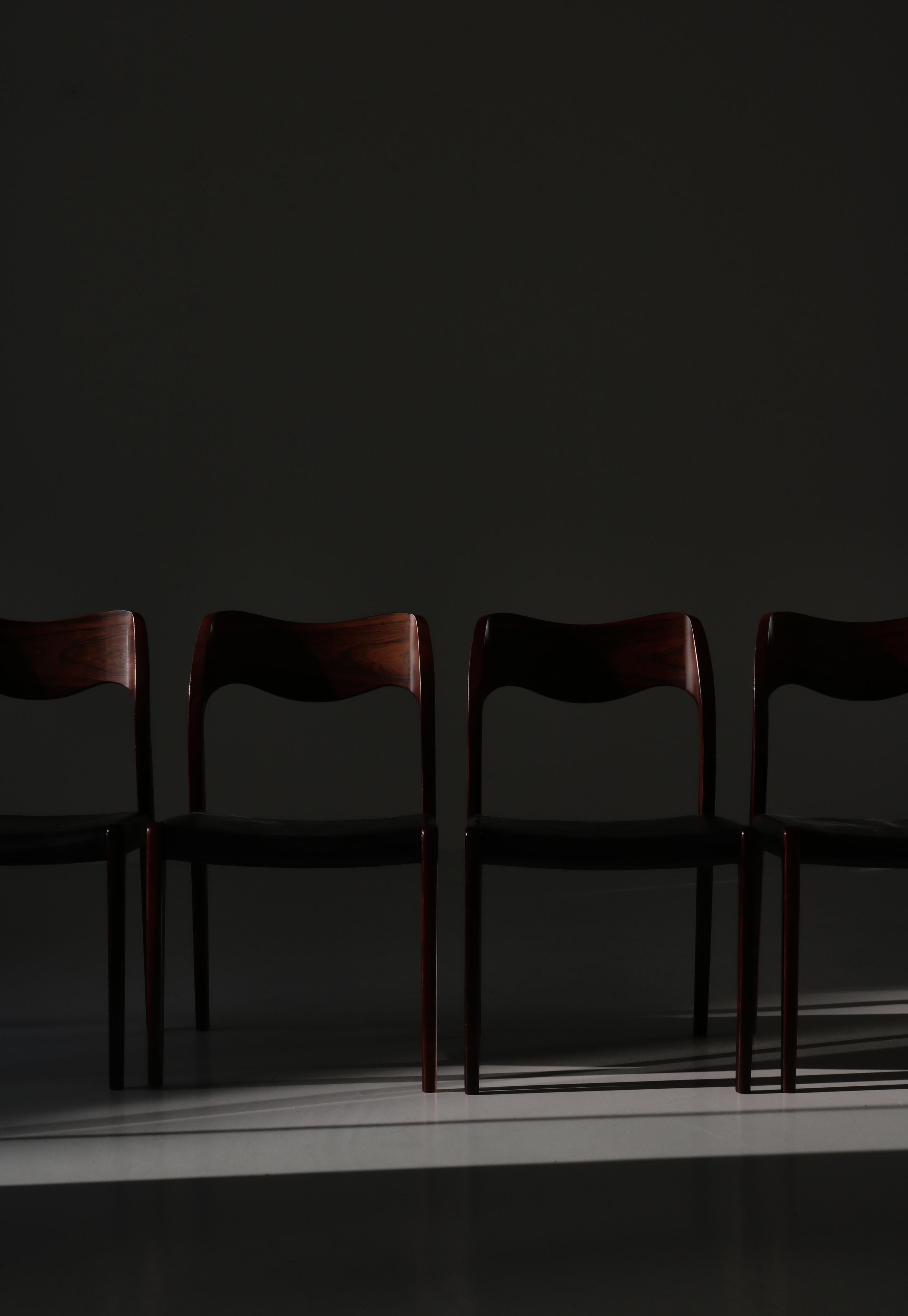 Set of 4 Danish Modern dining chairs by Niels Otto Møller (N.O. Møller) made in the 1950s at J.L. Møllers Møbelfabrik, Denmark. The chairs are made in the most beautiful solid rosewood and retains the original black leather. Marked by maker.

The