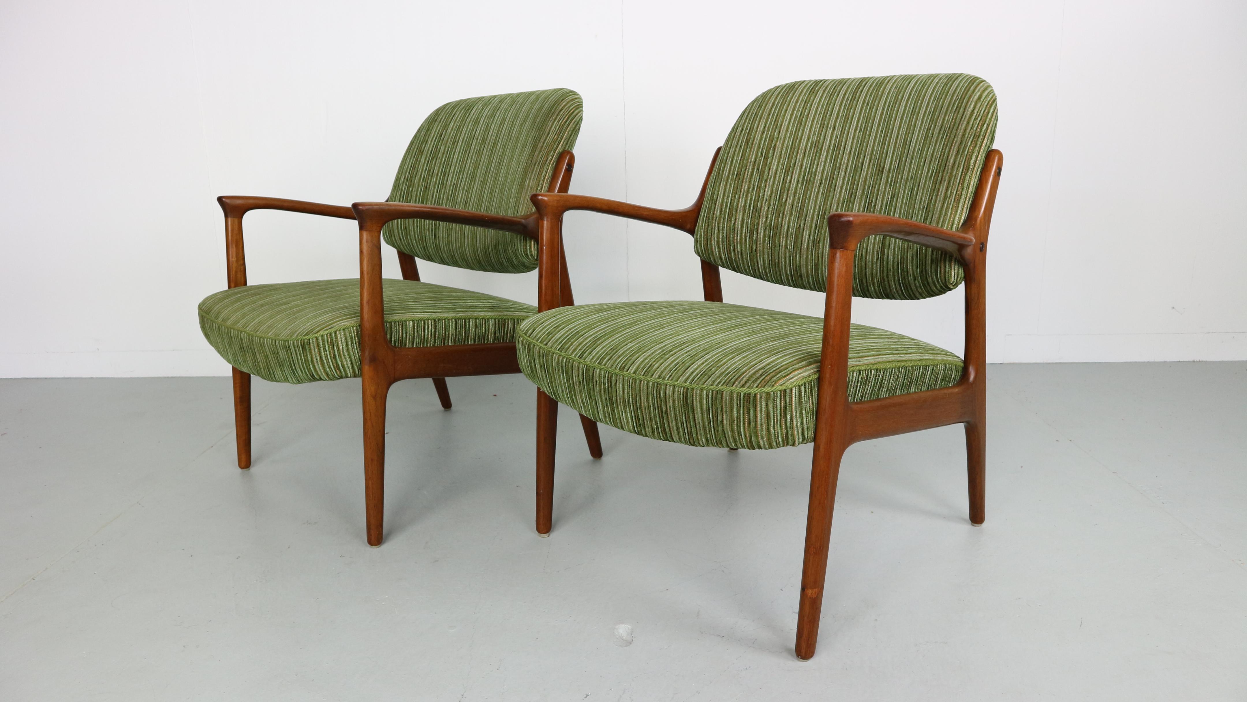 Pair of teak Danish armchairs with original green fabric. Organic curved armrests and solid wooden frame.