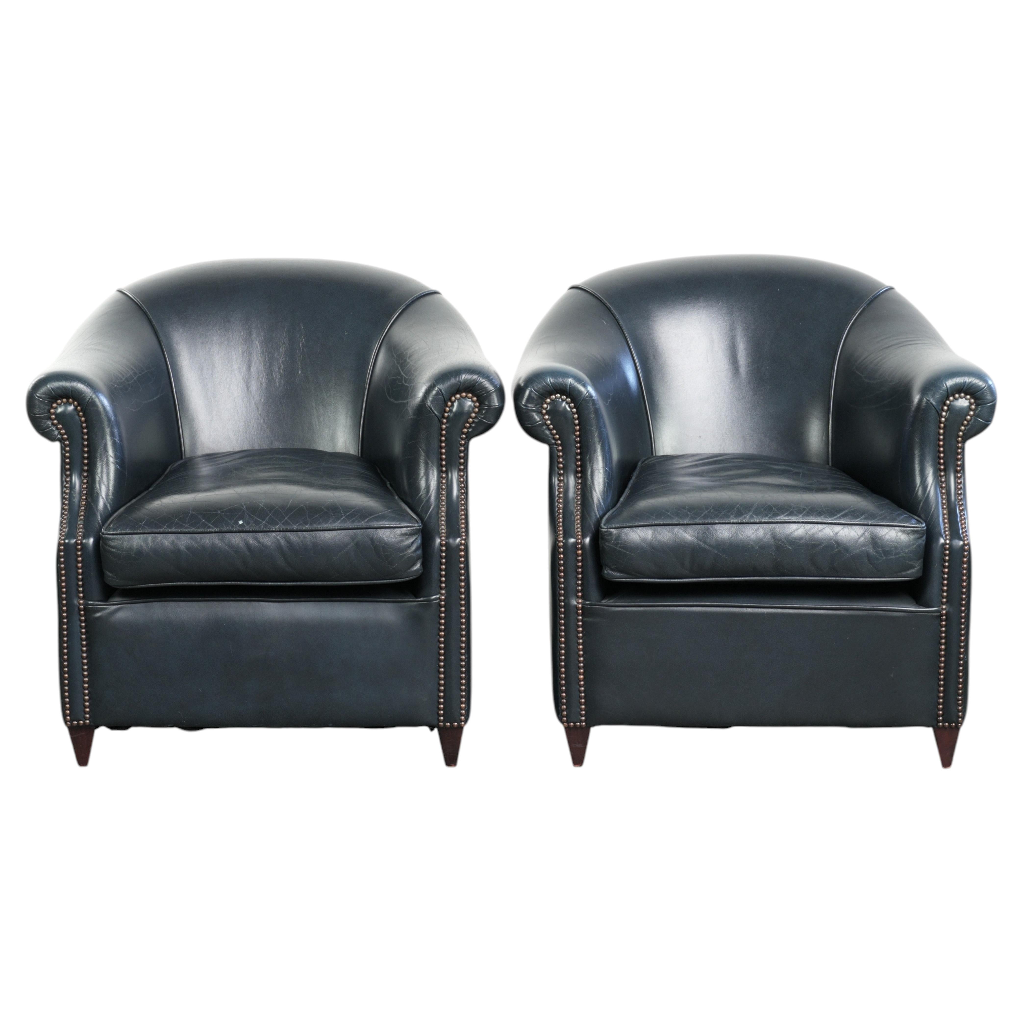 Set of dark blue cow leather club armchairs with a unique design