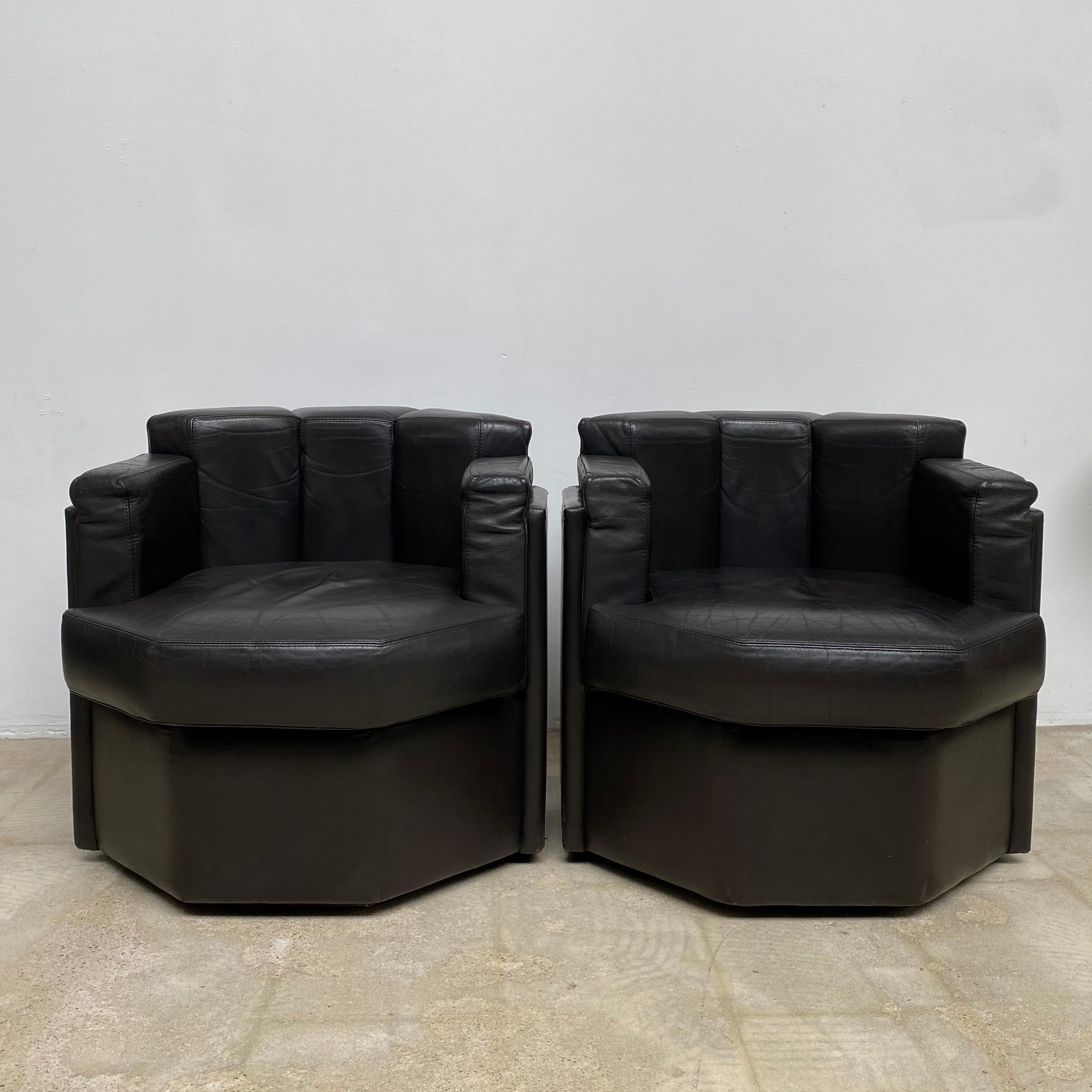 Set of dark brown octagonal club chairs, these uniquely shaped club chairs would very well suit an early 1970s James bond film set. The original segmented way of reupholstery makes these club chair both rare and unique in style and very comfortable