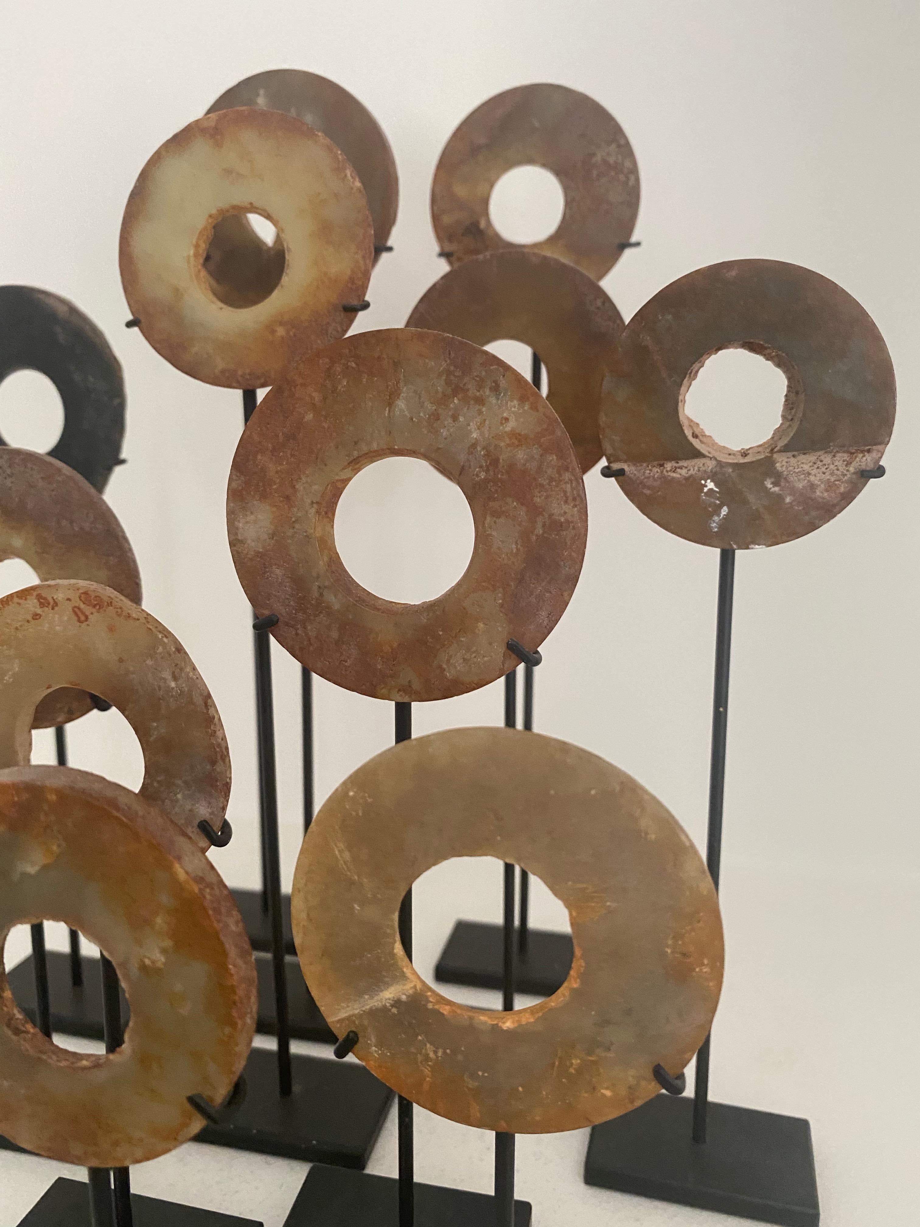 12 marble round objects on a metal stand,
China, 16 th century, used as a ritual and spiritual object,
great old patina,
height of stands between 12 and 15 cm.