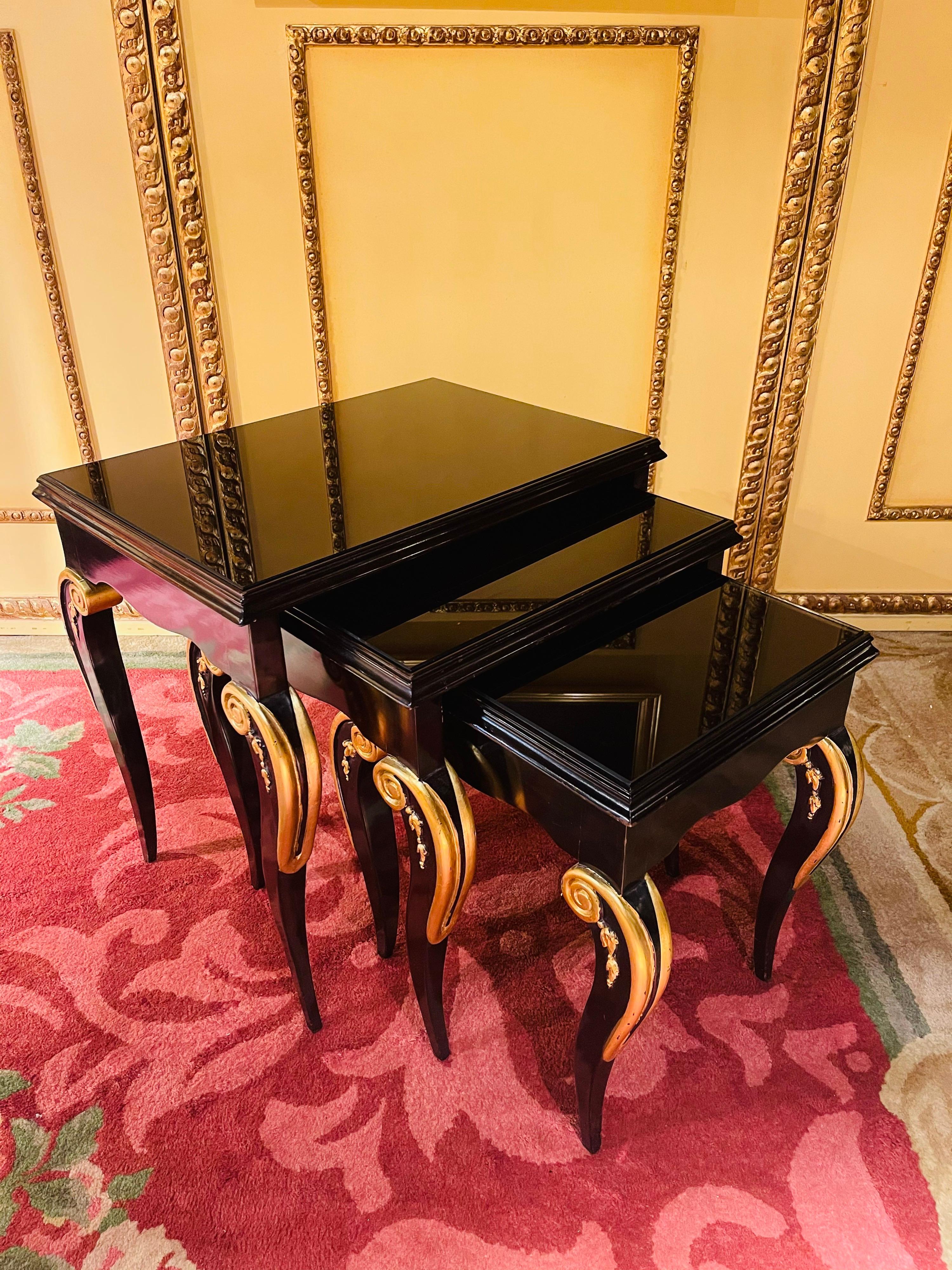 Set of designer 4 side table in Empire style

Solid beechwood black painted and partially gilded. Curved frame on curly long legs White taken. tabletop in black tinted, thick glass. The side table set is tiered and fits into each other. Classic,