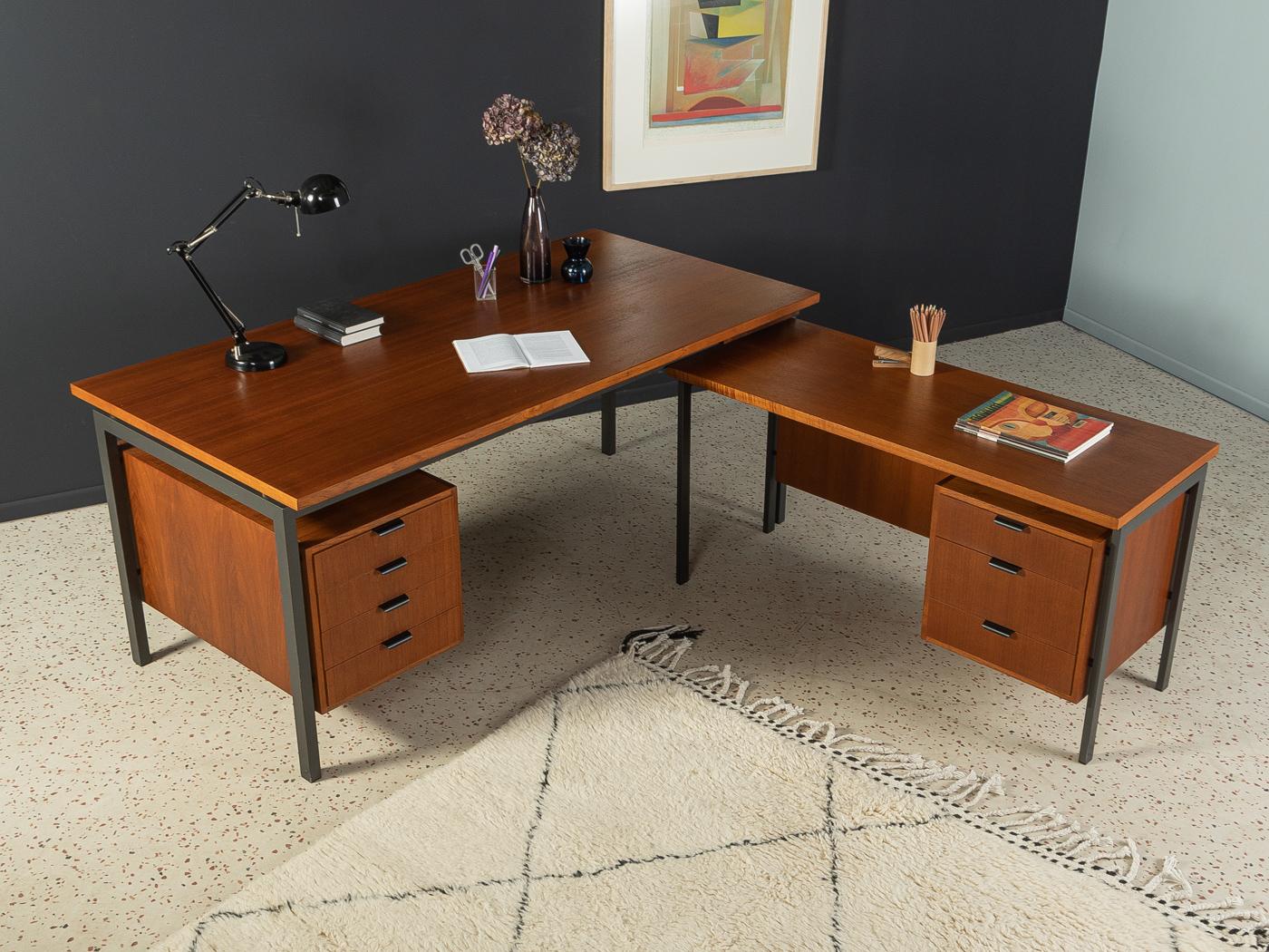 Rare set of desks consisting of two individual desks with high-quality metal frame in black, two containers in teak veneer, each with four respectively three drawers and a small pen drawer. The tables can be freely combined or used
