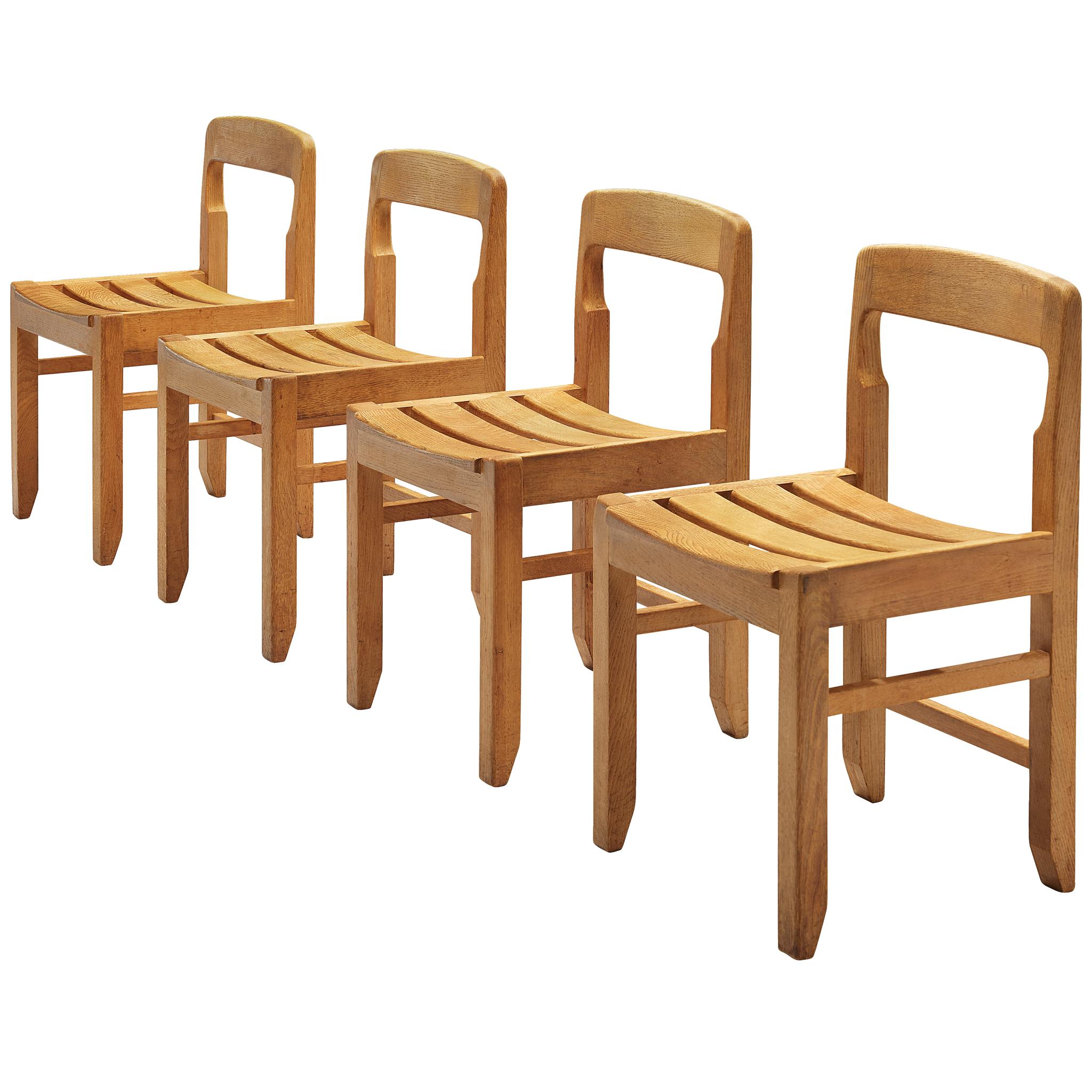 Guillerme et Chambron, set of four dining chairs, solid oak, France, 1960s.

Set of four exceptional and rare dining chairs in solid oak by Guillerme and Chambron. These chairs show the characteristic frame of this French designer duo. They feature