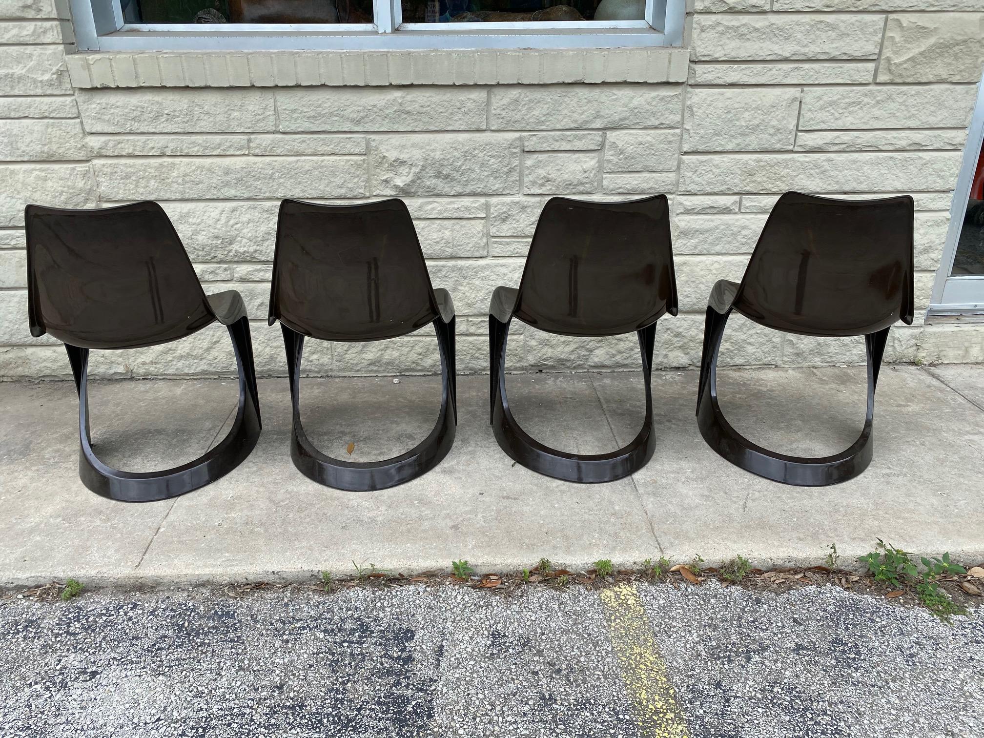 Dining chairs by Steen Østergaard for Cado (a-line model 290). This indoor/outdoor set includes four dark brown plastic chairs and are in good condition. Nominated 