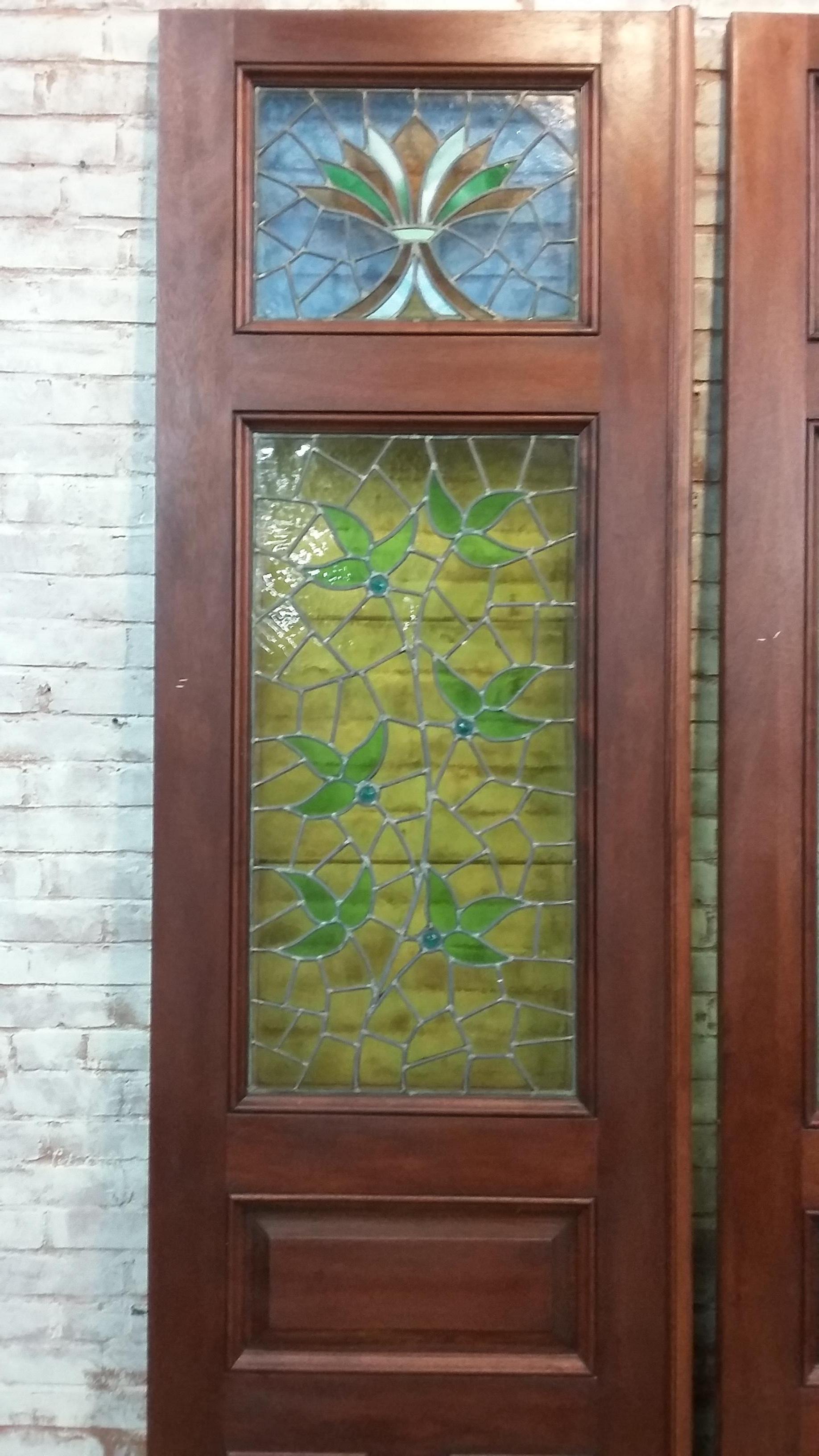 Set of doors with stained glass panels. Stained glass is vintage but doors are not antique.
Small crack on top right door each door is approx. 90