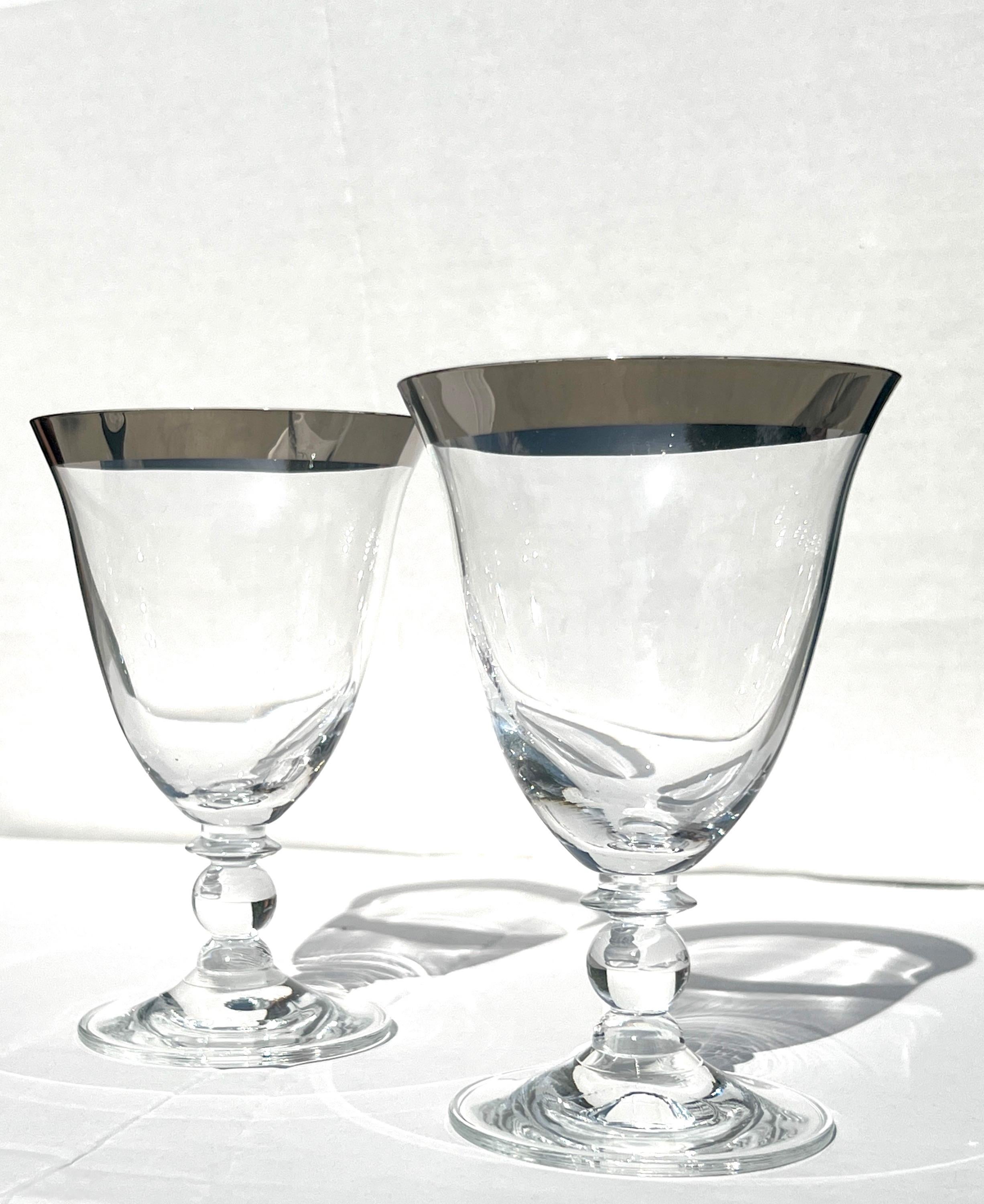 Set of four vintage water or wine goblet glasses by Dorothy Thorpe.  The blown glasses feature short stems with glass ball fittings and the iconic silver rim synonymous with Thorpe designs.  Make an elegant and cheerful addition to any dinnerware