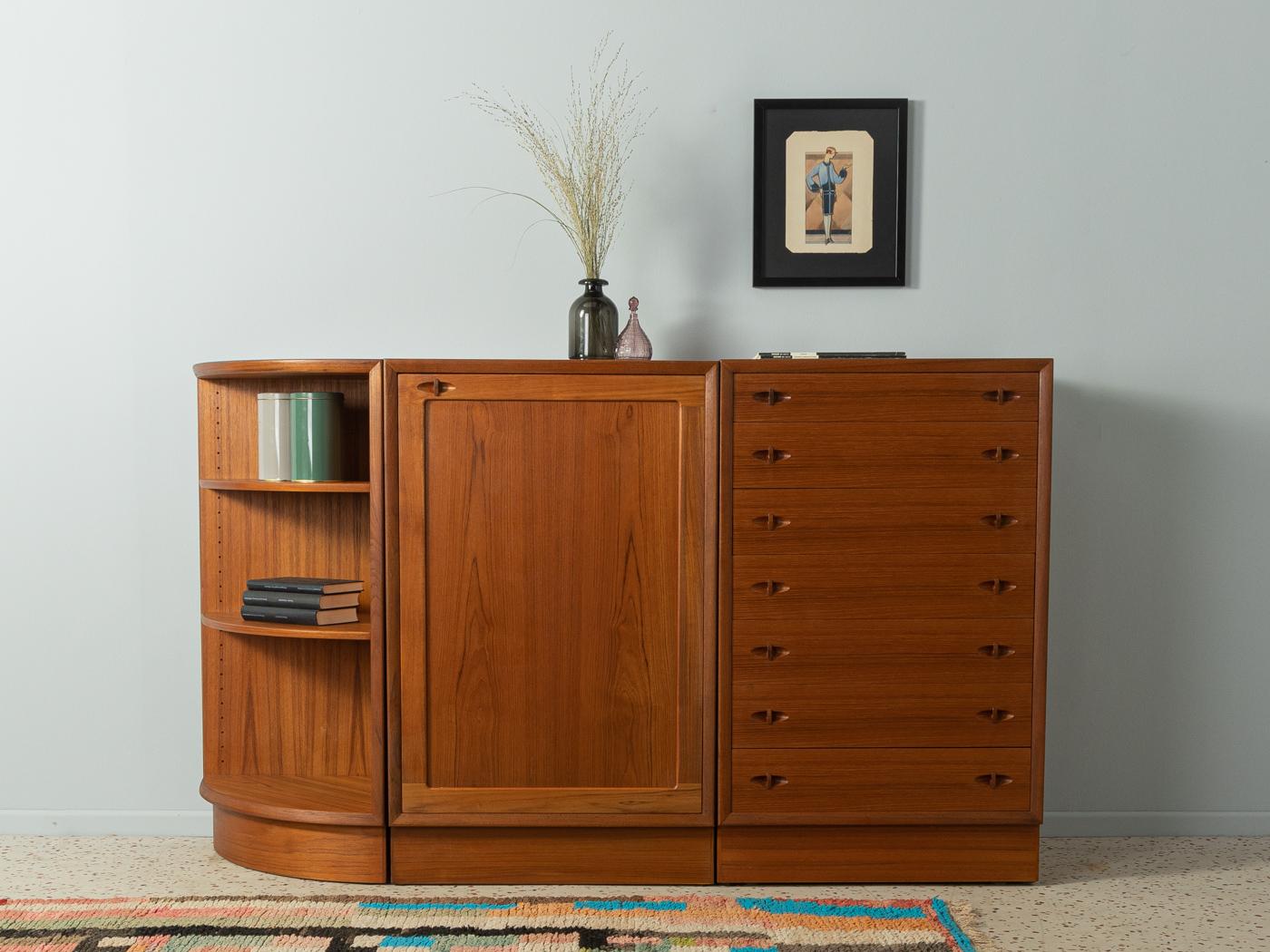 Wonderful dressers from the 1960s in Scandinavian design in teak veneer. One corpus with seven drawers, one corpus with three open book compartments, and a third corpus with one door and two shelves. All dressers stand on separate bases in teak, the