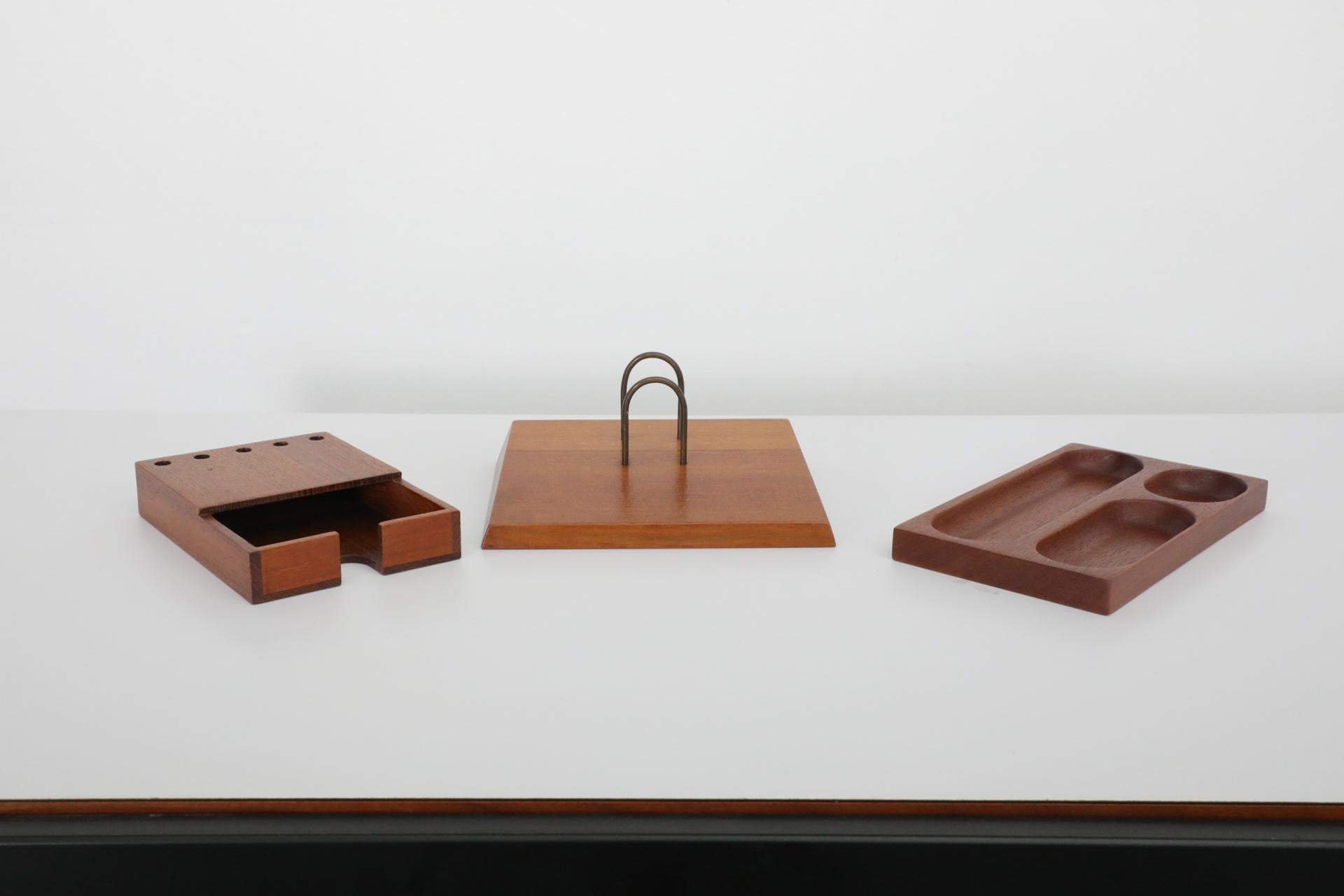 Dutch Mid-Century, Jens Risom inspired set of three beautifully designed teak desk accessories. Set contains a utensil storage tray (9 x 5.25 x .75), calendar holder -here used as a card holder- (5 x 7 x .75), and note paper box with pen/cil