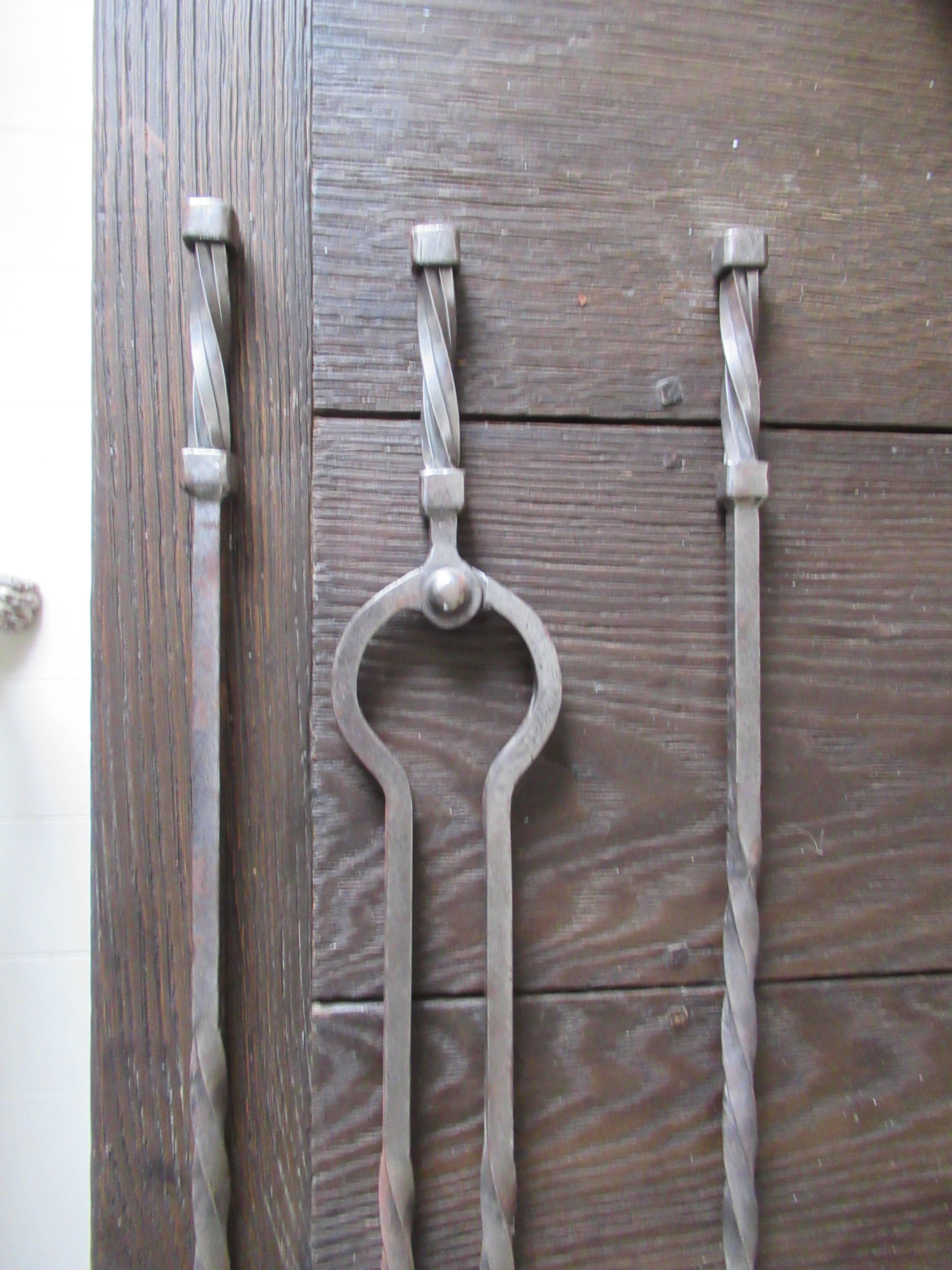 Late 18th century. A set of three early Gothic twisted steel fire irons of large size.
    