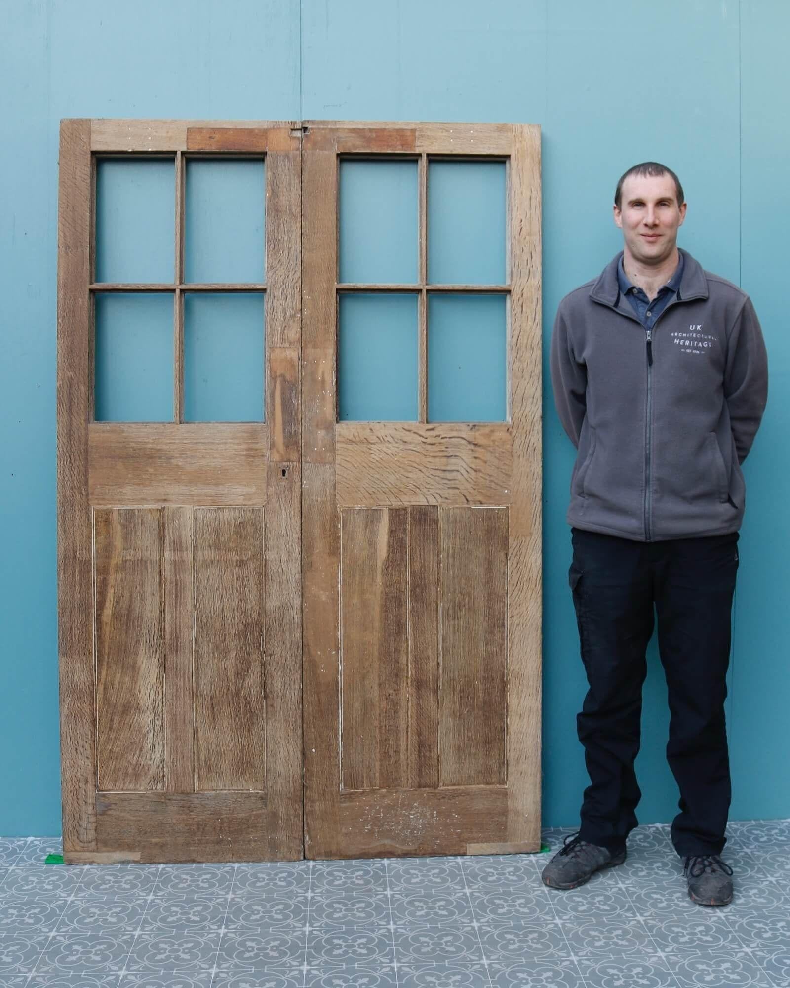 A beautiful set of unglazed Edwardian stripped oak double doors circa 1900 suitable for interior or exterior use. These reclaimed doors are of handsome quality and craftsmanship, each designed with 4 empty panes for custom glazing of your choice