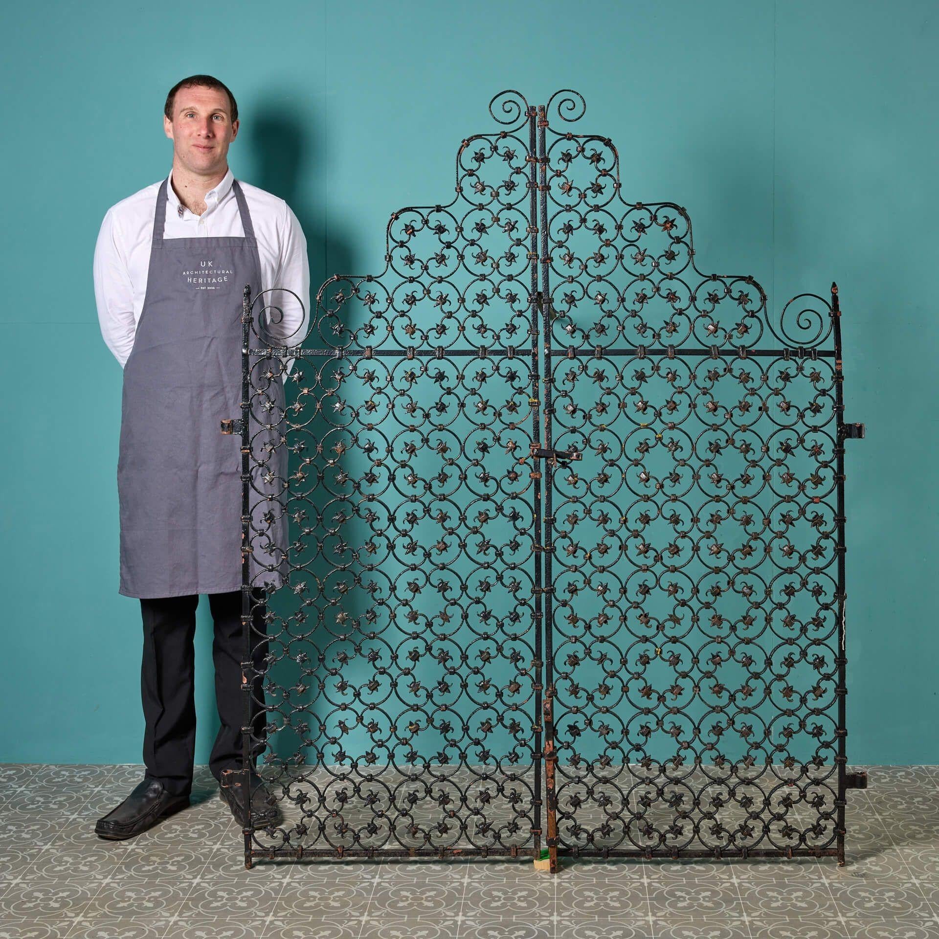 These Edwardian era wrought iron garden gates circa 1900 bring instant grandeur to a garden with their ornate craftsmanship and abundance of repeating scrollwork. They have stood the test of time for more than 120 years and as such would look