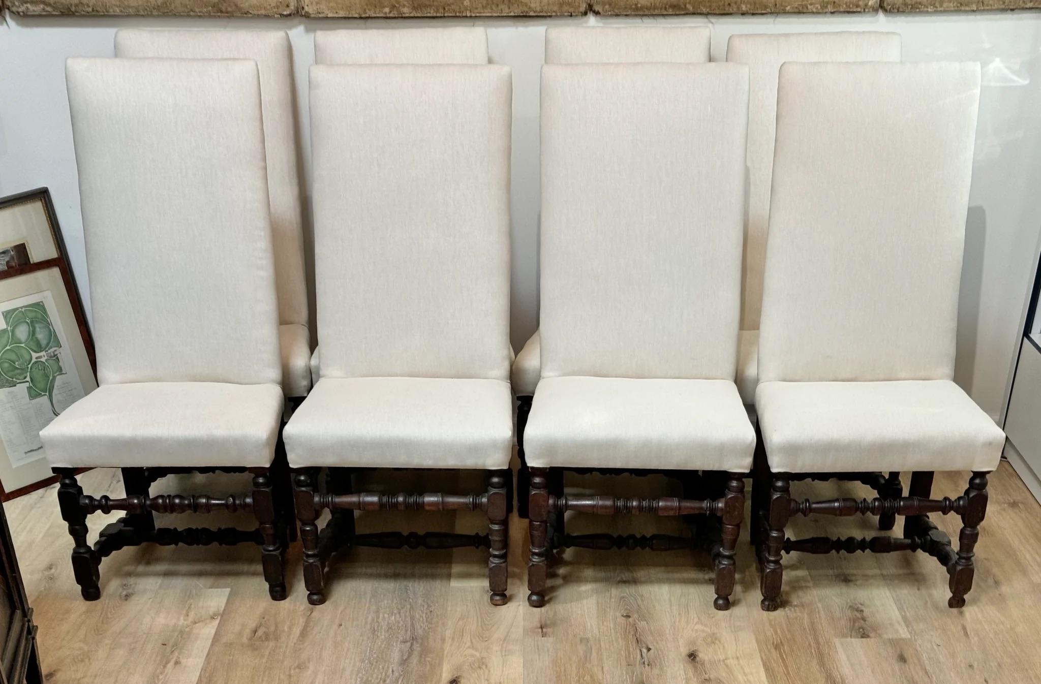 Assembled Set of Eight William and Mary Walnut Dining Chairs, Eighteenth Century and Later. Each tall, rectangular upholstered back above a Belgian linen  over-upholstered seat, raised on block, vase and ring-turned legs joined by matching