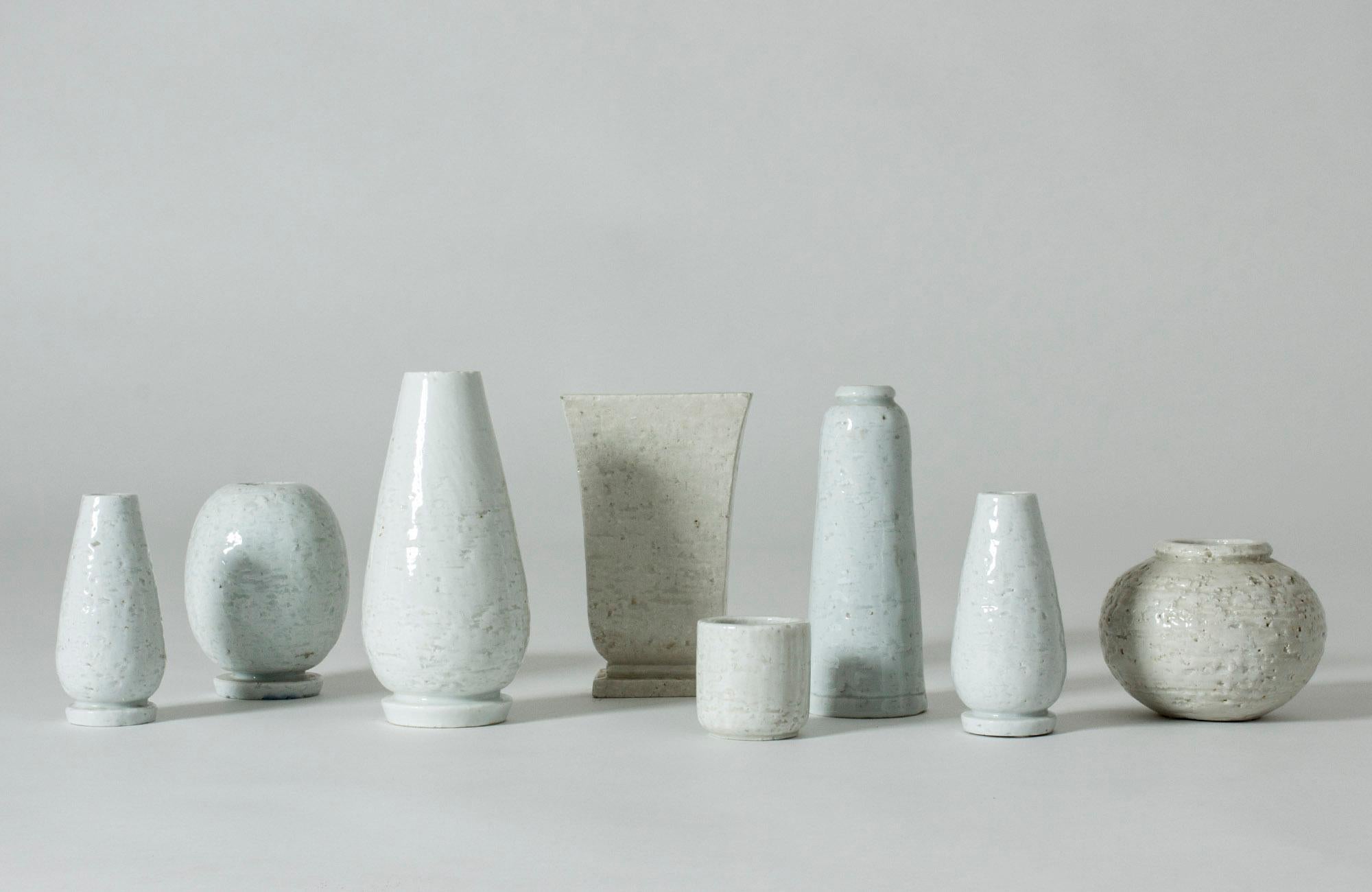Set of eight amazing “Chamotte” stoneware vases by Gunnar Nylund, made in a technique where crushed earthenware is mixed into the stoneware. The series was introduced in 1936 and stood in contrast to the smooth forms otherwise popular at the time.