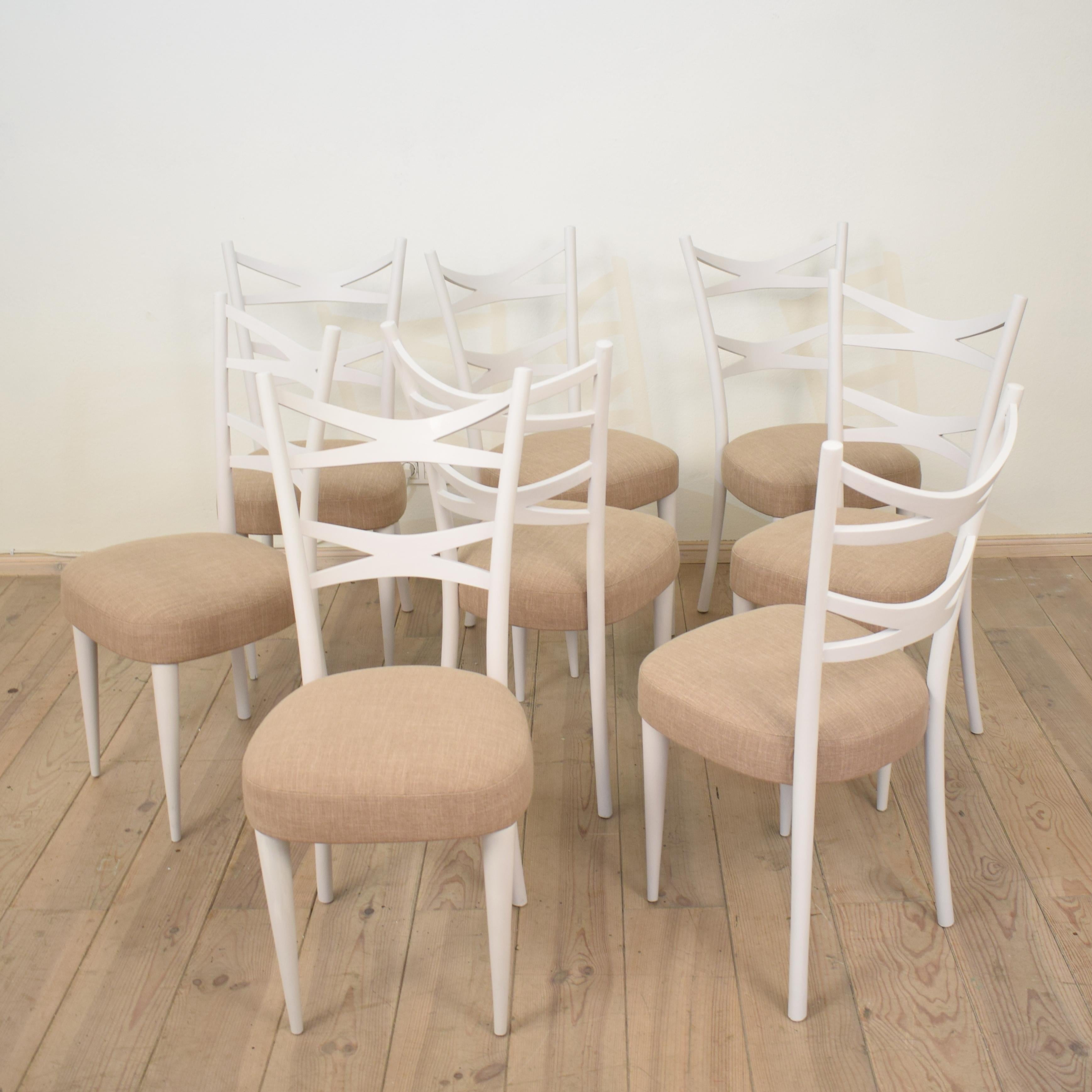 This elegant Set of Eight Dining Chairs where made in the Manor of Osvaldo Borsani in the 1940s in Italy.
They got repainted in a grey white color and re-upholstered in a beige linen cover.
The chair is very comfortable to sit because of its bowed