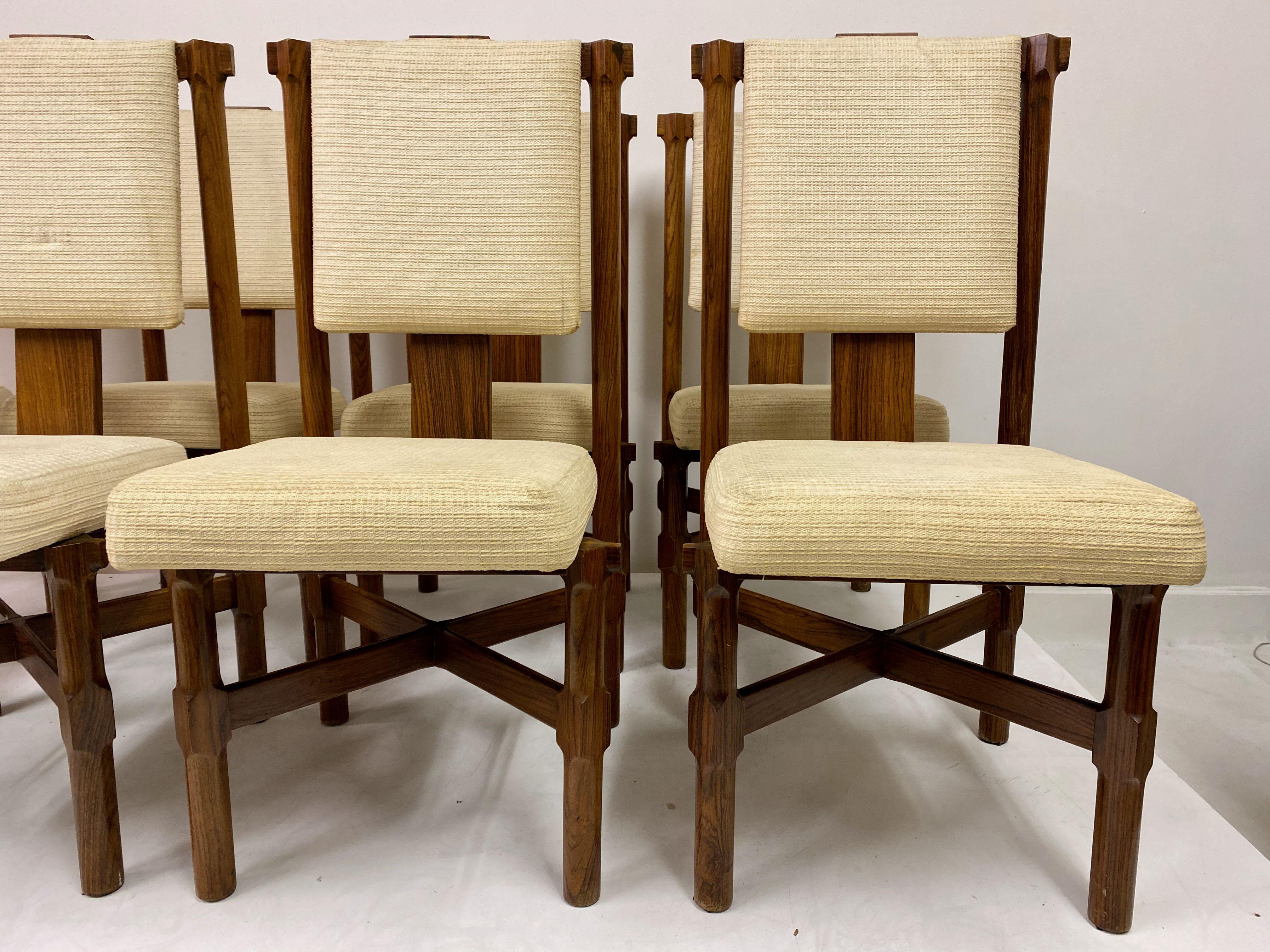 Set of eight dining chairs

Iroko frame

High backs

Measures: Seat height 45cm

Requires re-upholstery

Italy, 1970s.