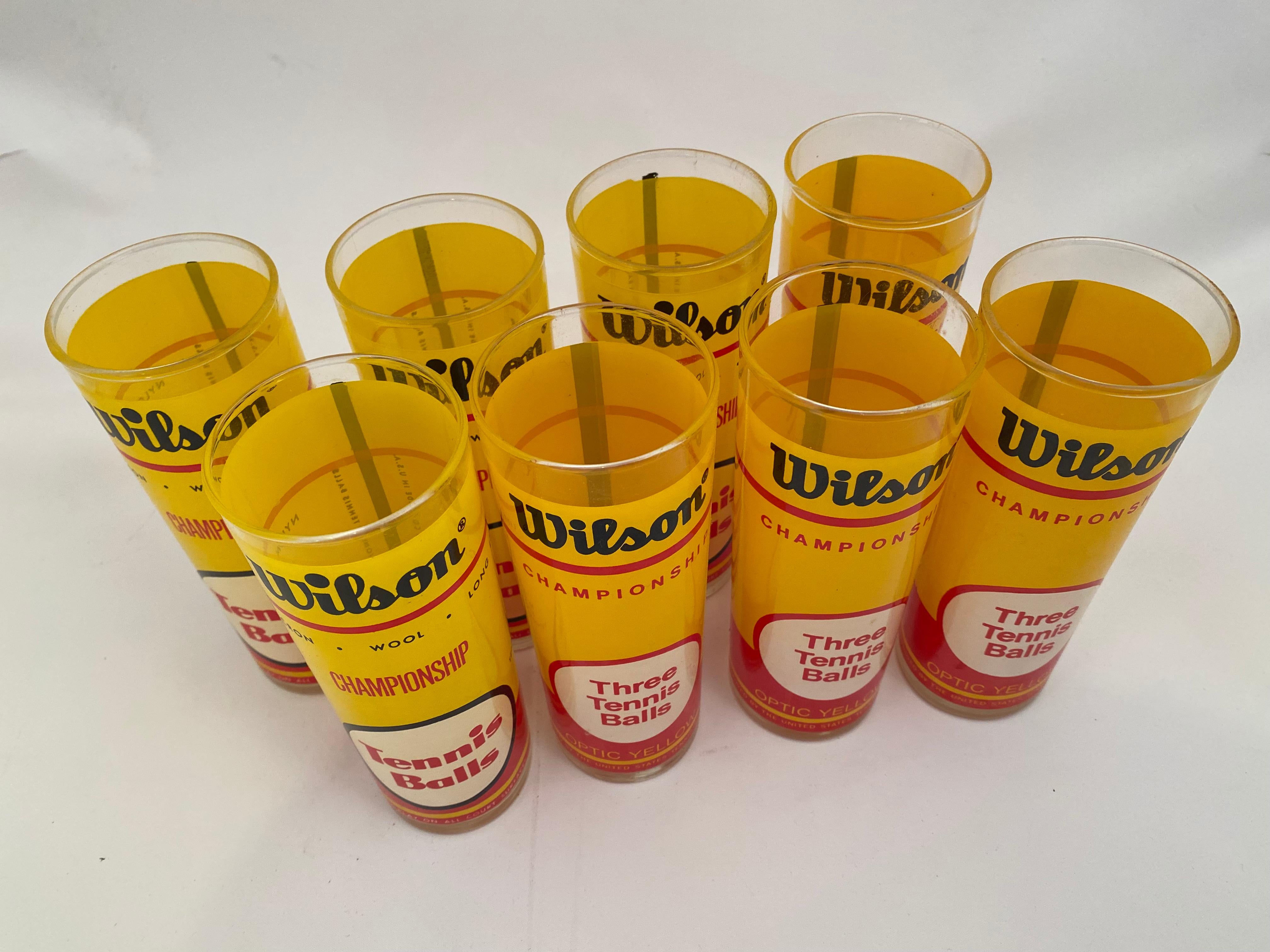 Set of eight vintage 1970s Wilson Tennis Ball screen printed tall Collins glasses. These are a lot of fun. Very good condition with great vibrant graphics. There are two similar, yet different sets of four; the font and text are slightly different