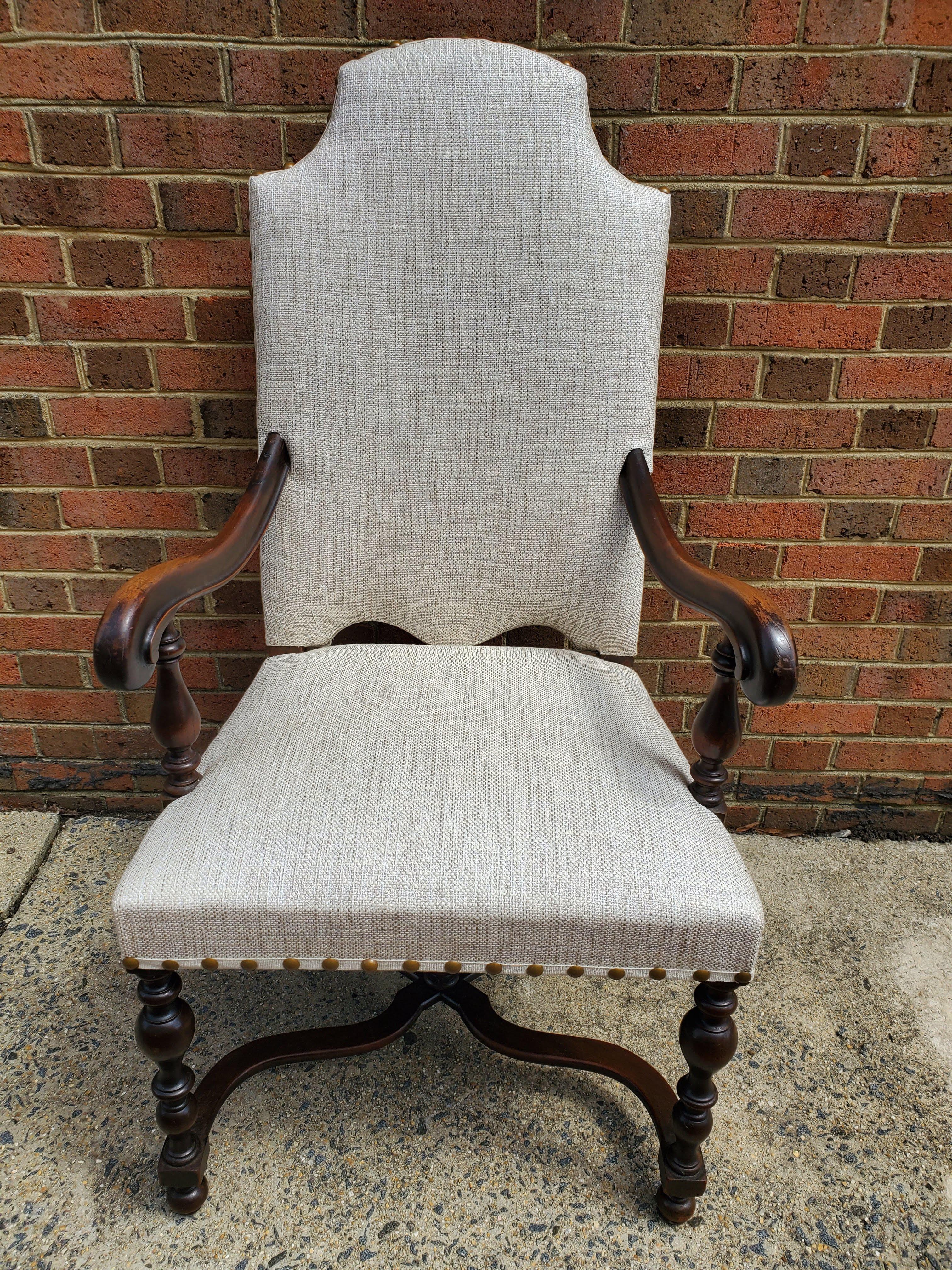 This set of eight Baroque styled French armchairs are simply gorgeous. Old world meets modern with new linen upholstery and nailhead decorations creating a stunningly sophisticated look. Made of richly patinated walnut with decoratively shaped