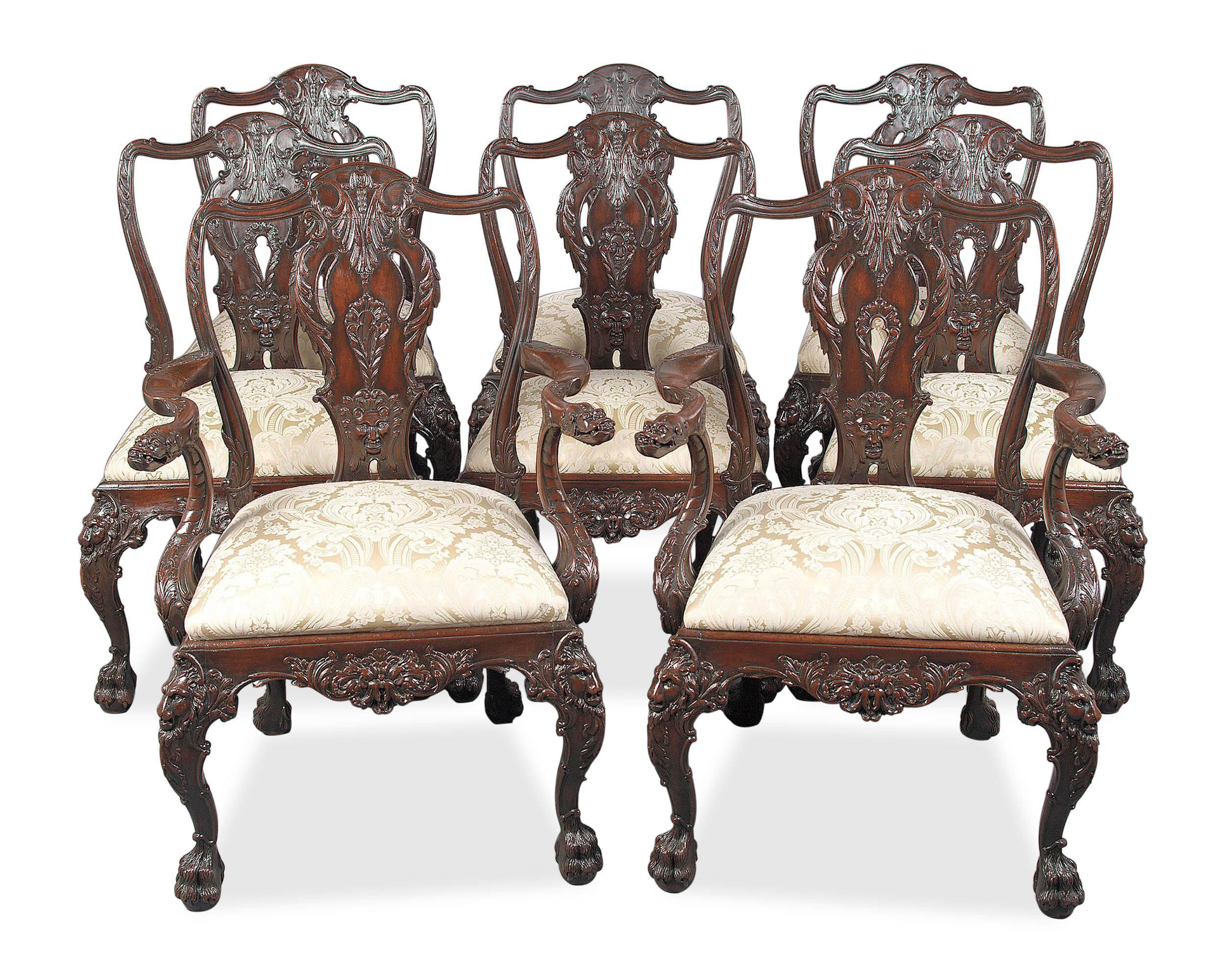 Luxuriously carved, this wonderful set of eight English Victorian antique dining chairs is patterned after the 18th-century design by important furniture maker Giles Grendey (1693-1780) of London. The serpentine crests, leaves, satyr and lion masks,