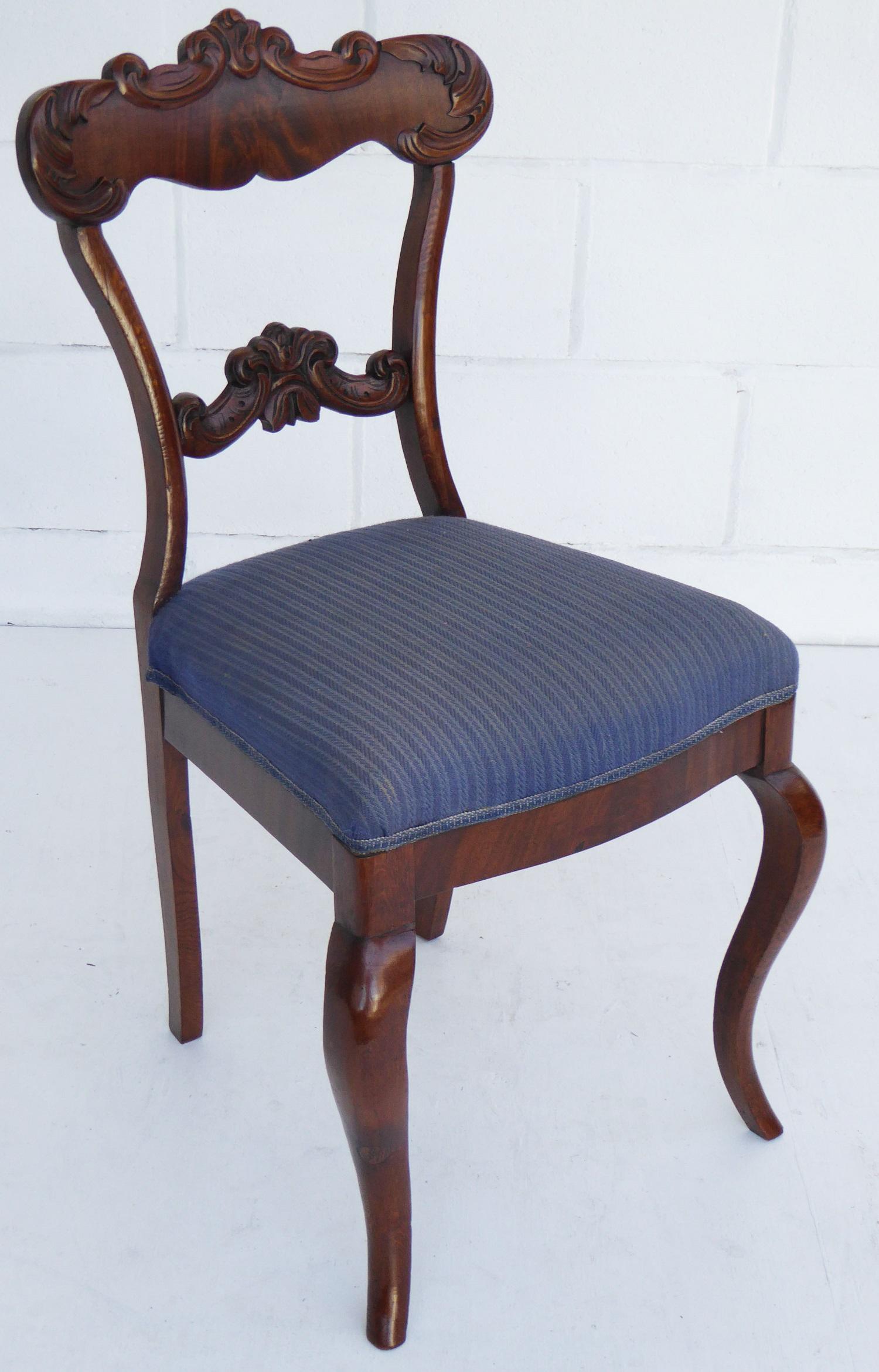 For sale is a set of 8 19th century oak and mahogany dining chairs. Each chair has an ornately shaped and carved back rail, above an upholstered seat, standing on shaped legs. Each chair has been re-finished by hand and is in good