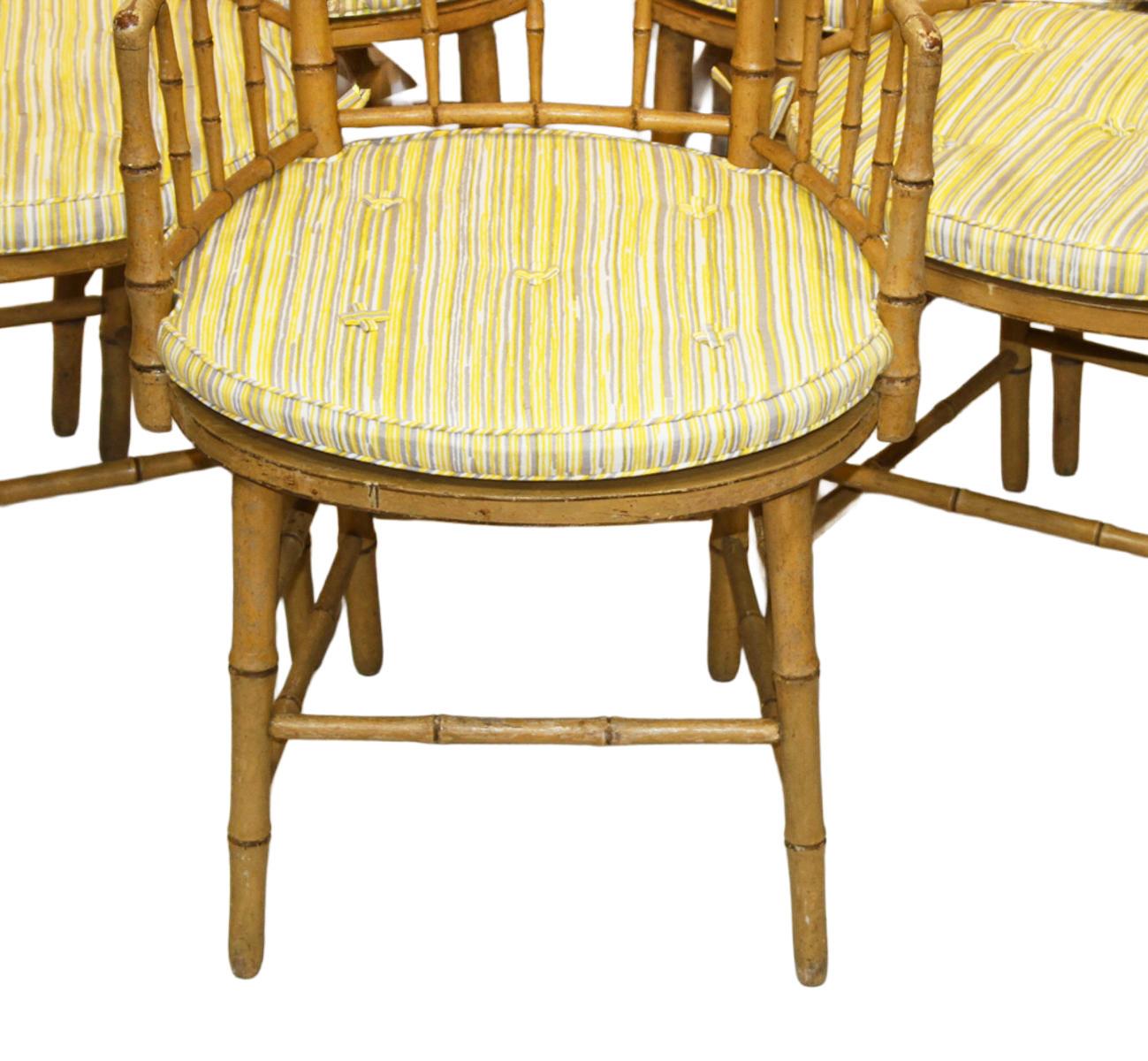 A rare collection of eight 19th-century faux bamboo armchairs, retaining their original mustard-yellow paint finish and exhibiting a pleasing, authentic patina. The caned seats have been meticulously replaced and are now in excellent condition and