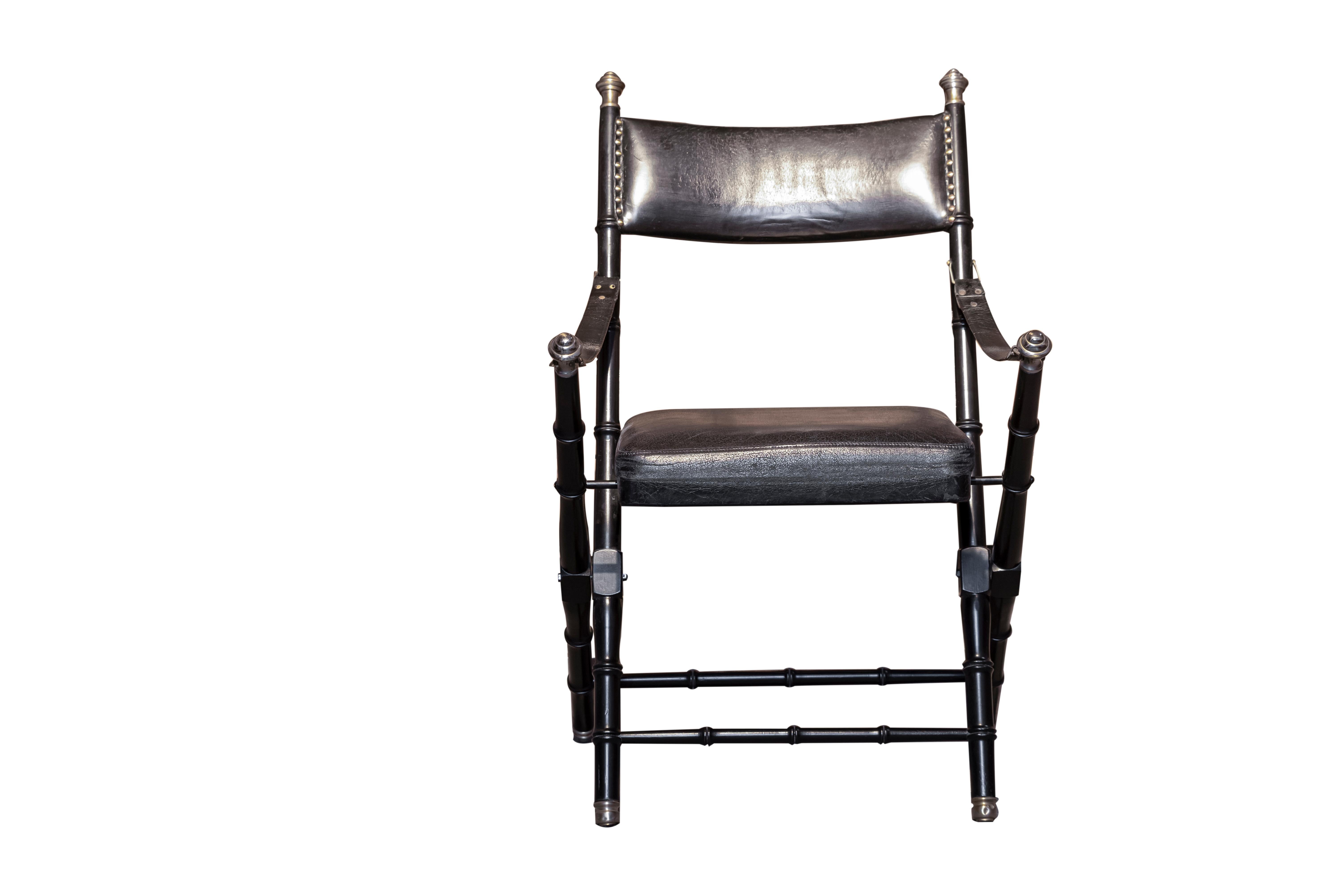 Set of eight black leather campaing chairs by Maison Jansen. Faux bamboo eboniced wood structure with brass decorative details.