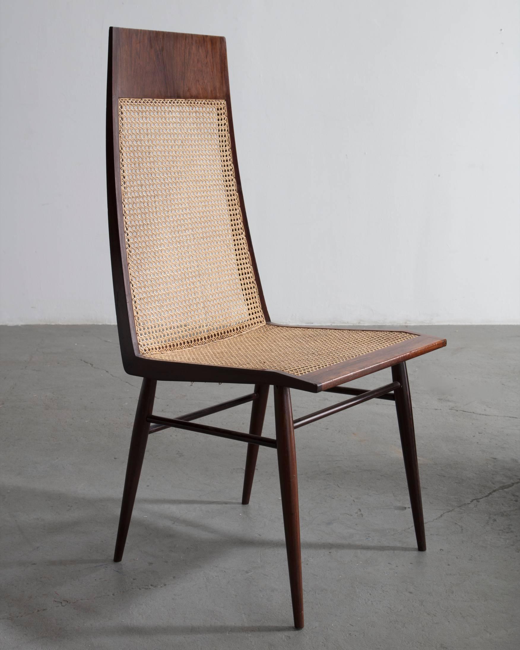 Set of eight (8) dining chairs in rosewood with cane seat and back. Designed by Joaquim Tenreiro, Brazil, circa 1949 (seat: 17.75