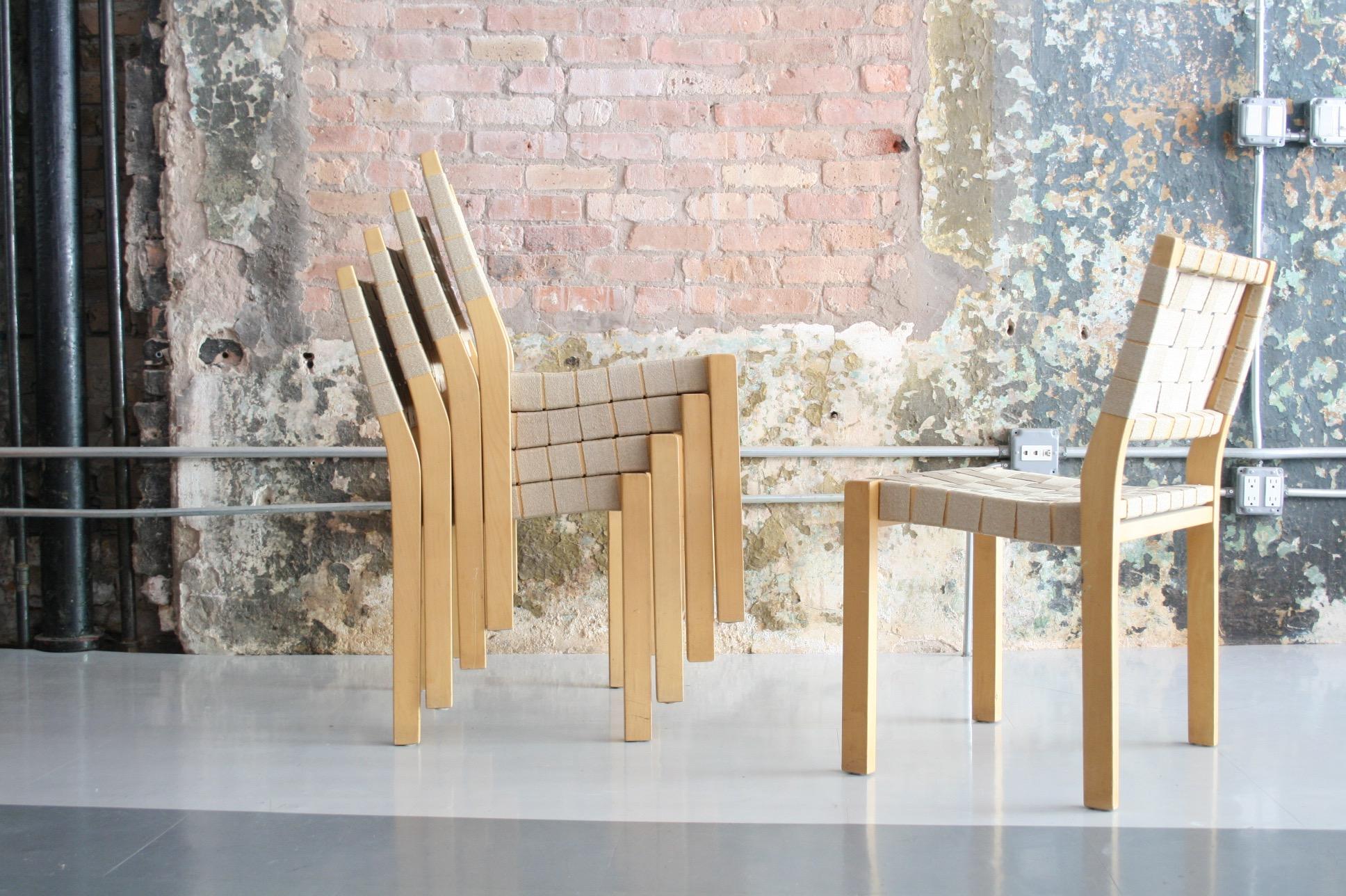 A set of eight Alvar Aalto 615 chairs with birch frames and flax webbing. Chair has a birchwood frame and high-quality 2