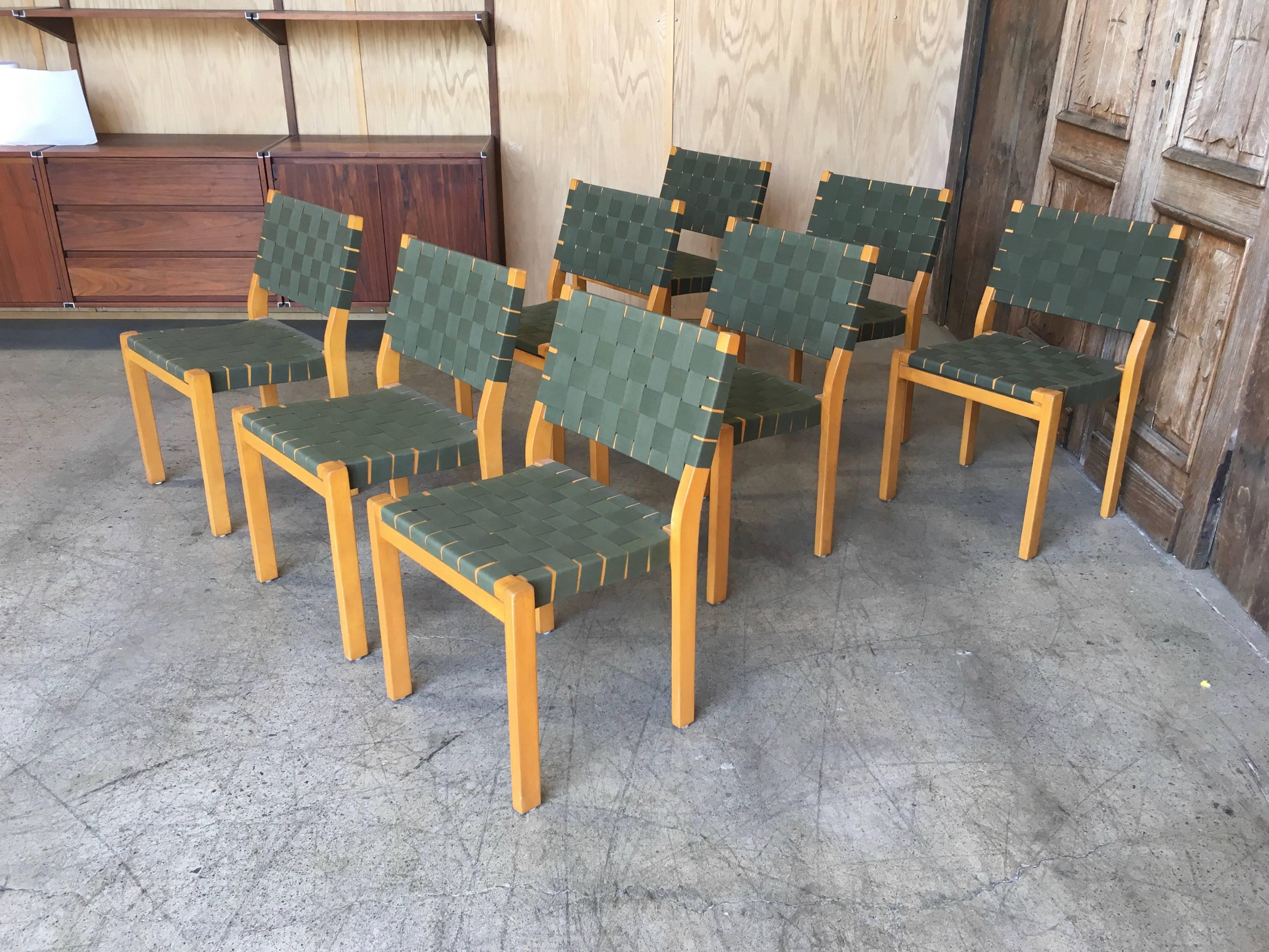 Eight model 611 chairs in birch with linen webbing by Alvar Aalto, Finland.
 