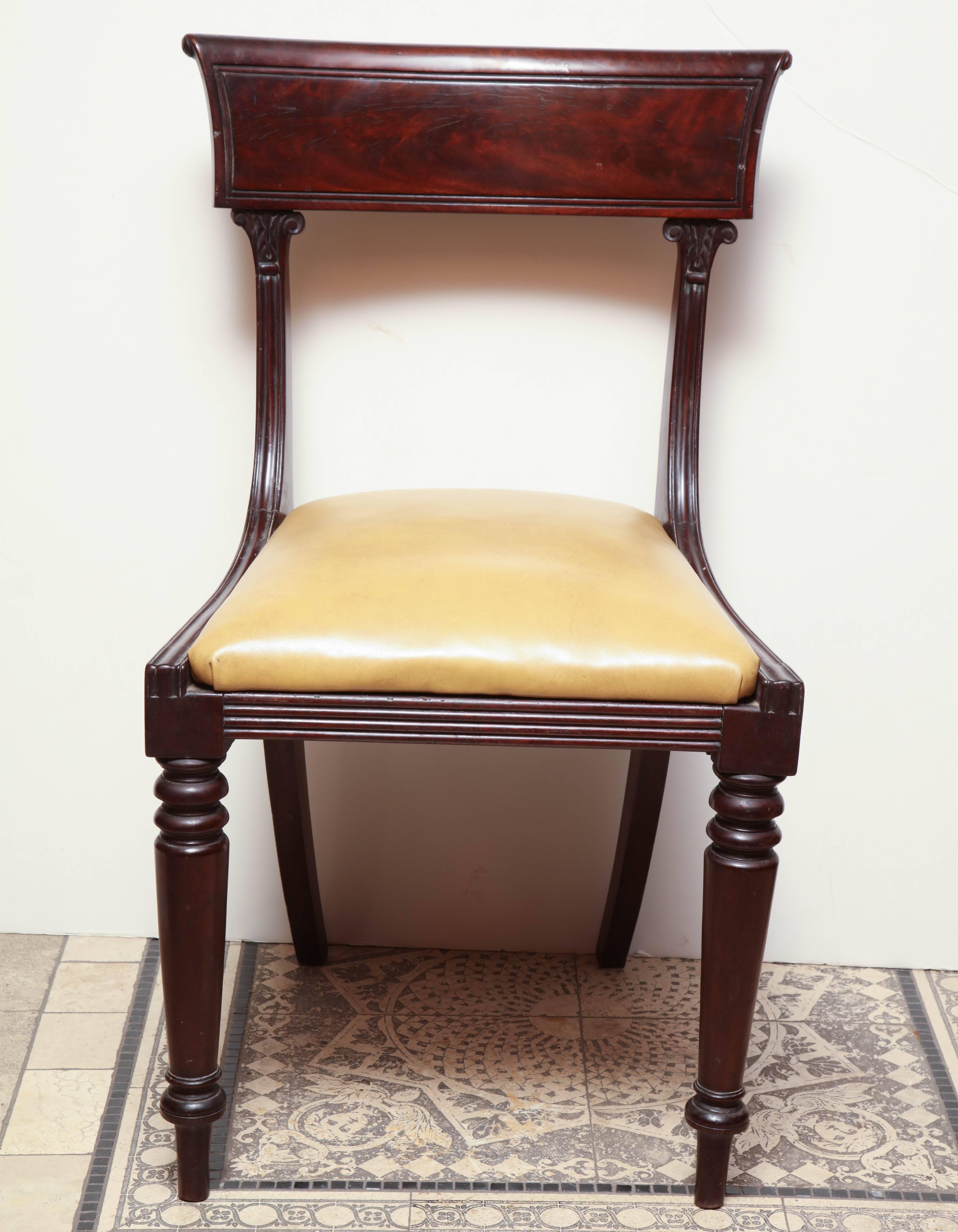 A set of eight American Classical mahogany dining chairs with reeding and turned and tapered legs.