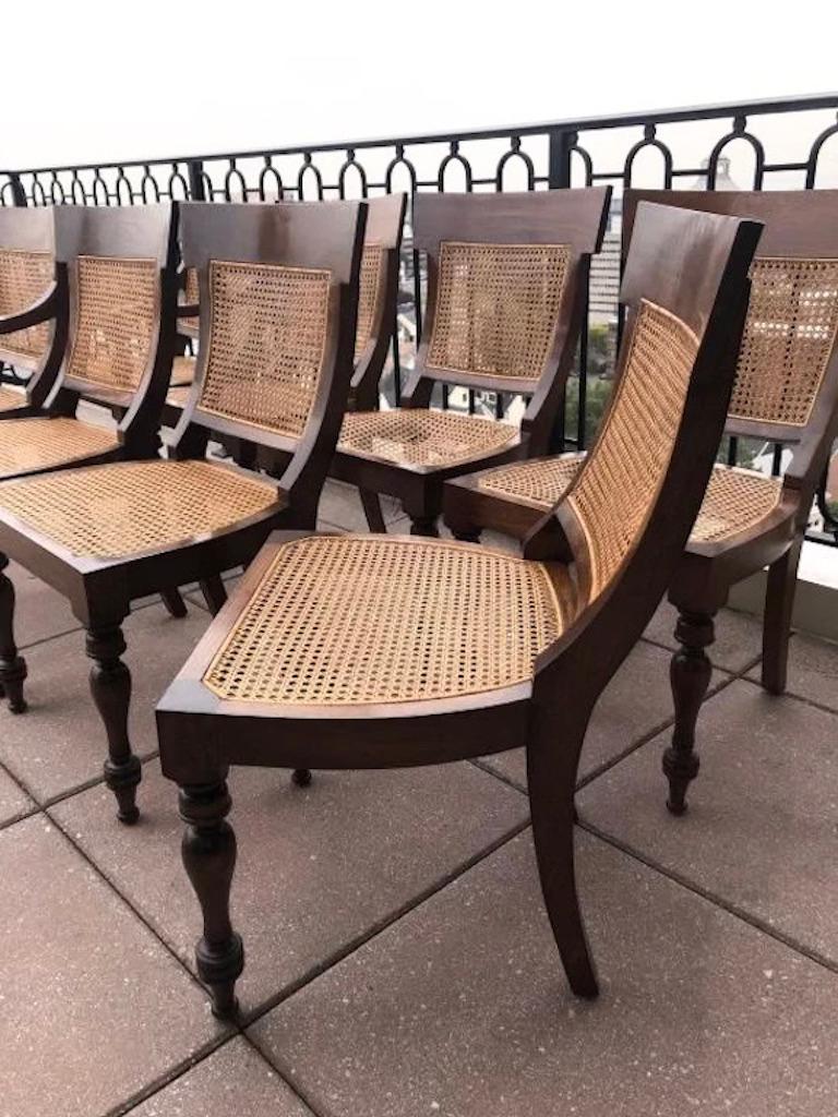 Set of eight rosewood Anglo-Indian Regency style dining chairs. Caned seats and back.

Caned backs and seat. Measures: 2 armchairs 37 inches x 23 inches x 23 inches, and 6 side chairs
37 inches x 21 inches x 21 inches. Chairs are 18 inches from