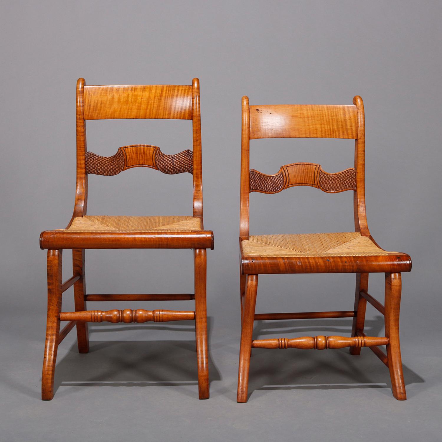 A set of 8 antique dining chairs offers deeply striated tiger maple construction with scrolled and shaped ladder backs over rush seats, handmade with some variation in size as photographed, circa 1860.

***DELIVERY NOTICE – Due to COVID-19 we are